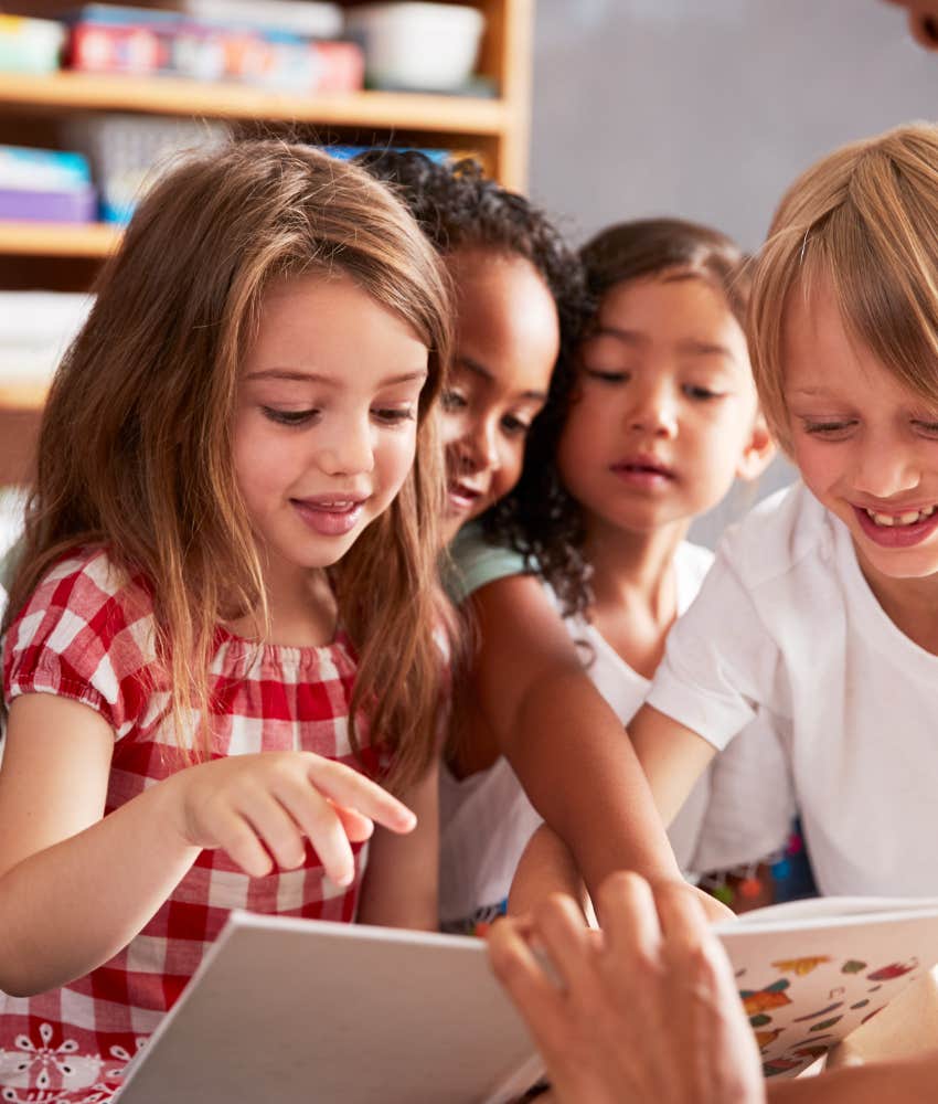 school kids looking at picture book