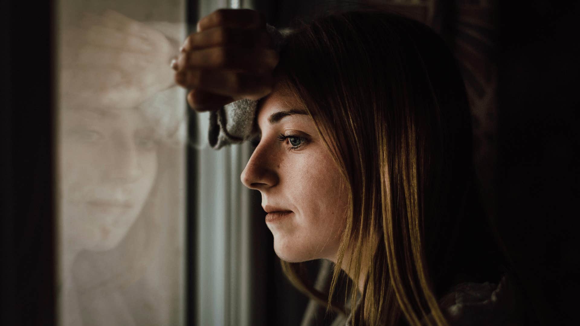 woman sad looking out window