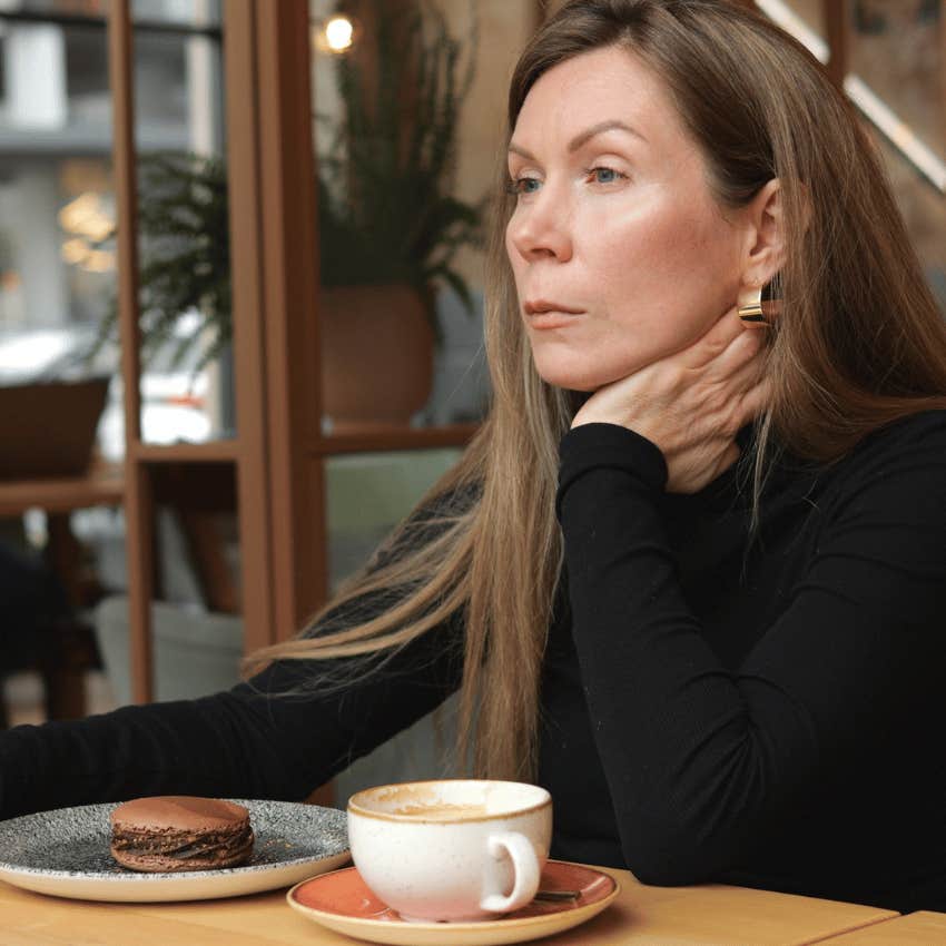 serious woman sitting at cafe alone