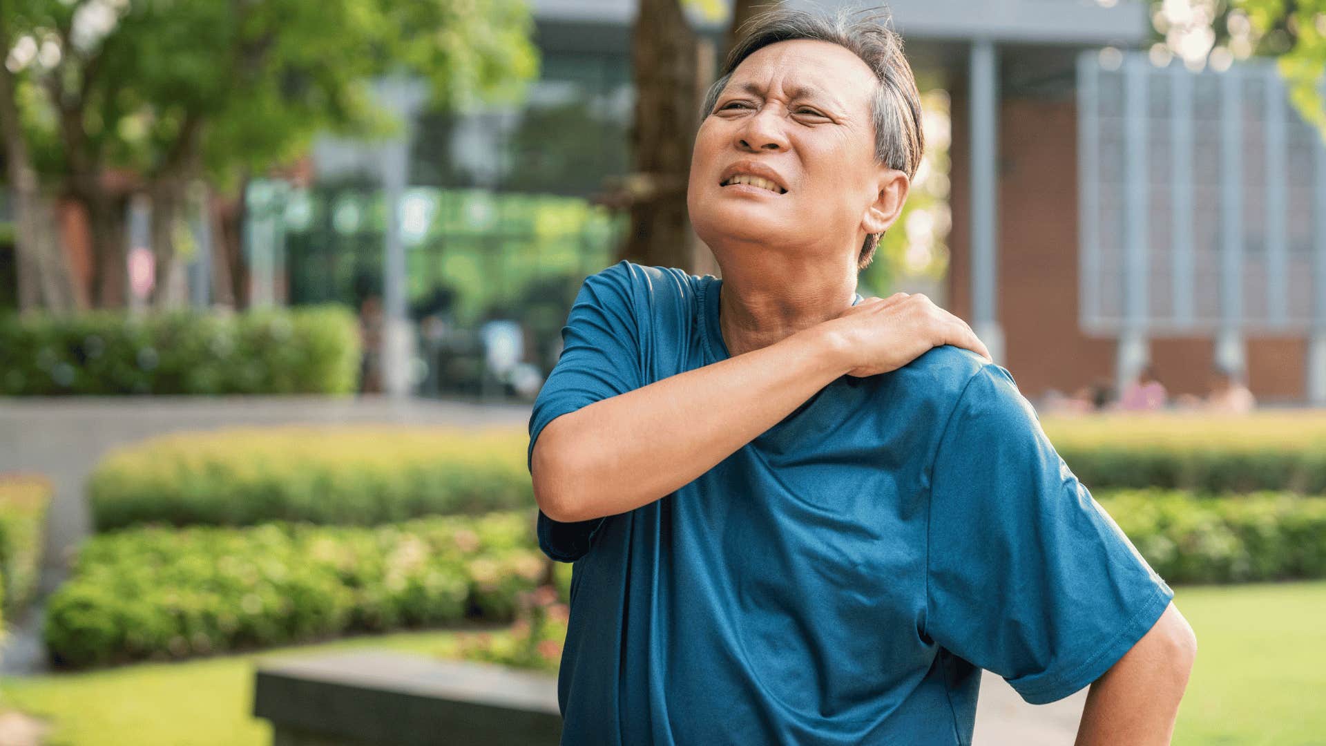 man rubbing shoulder in pain 