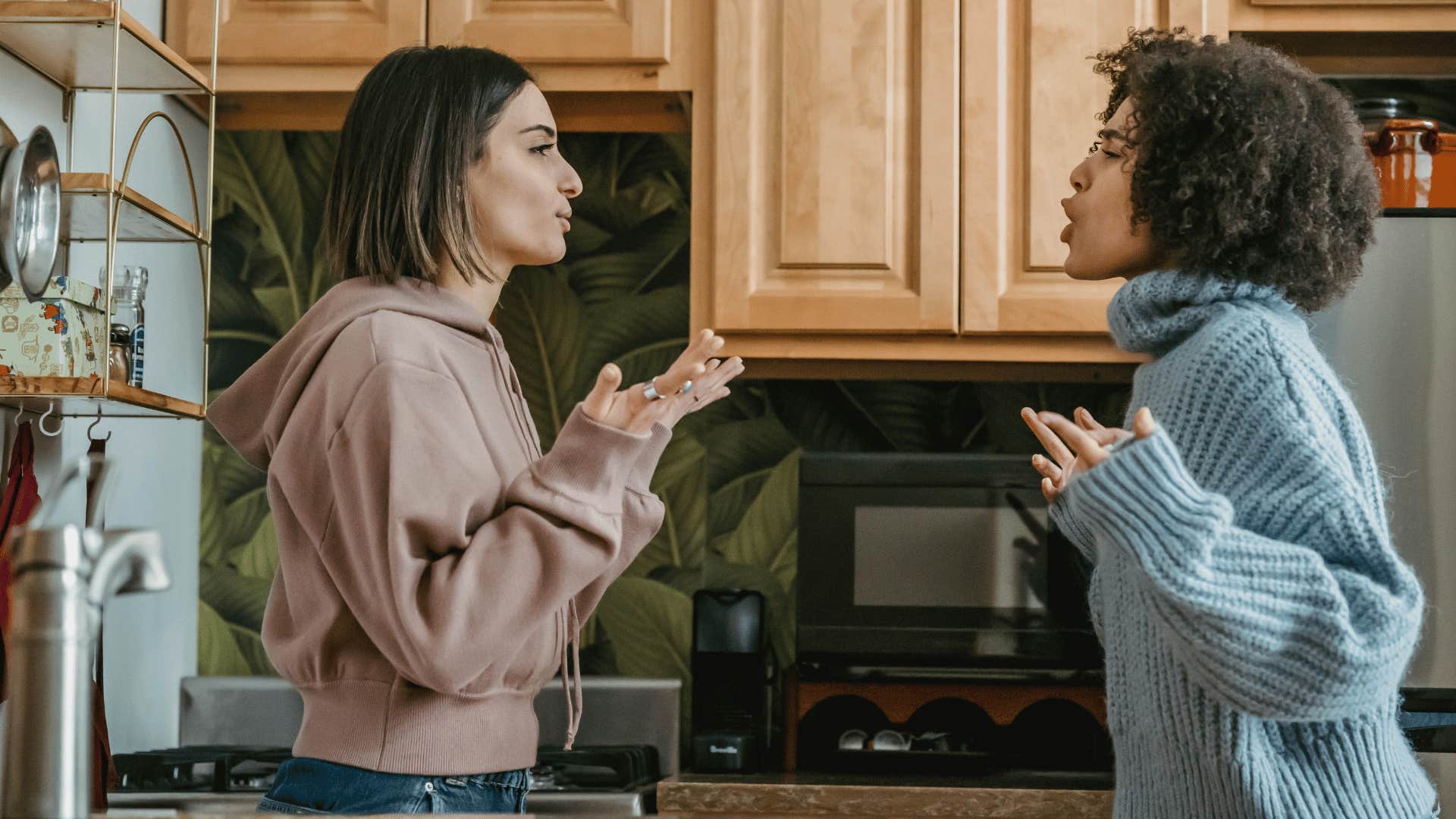 two women arguing in kitchen 