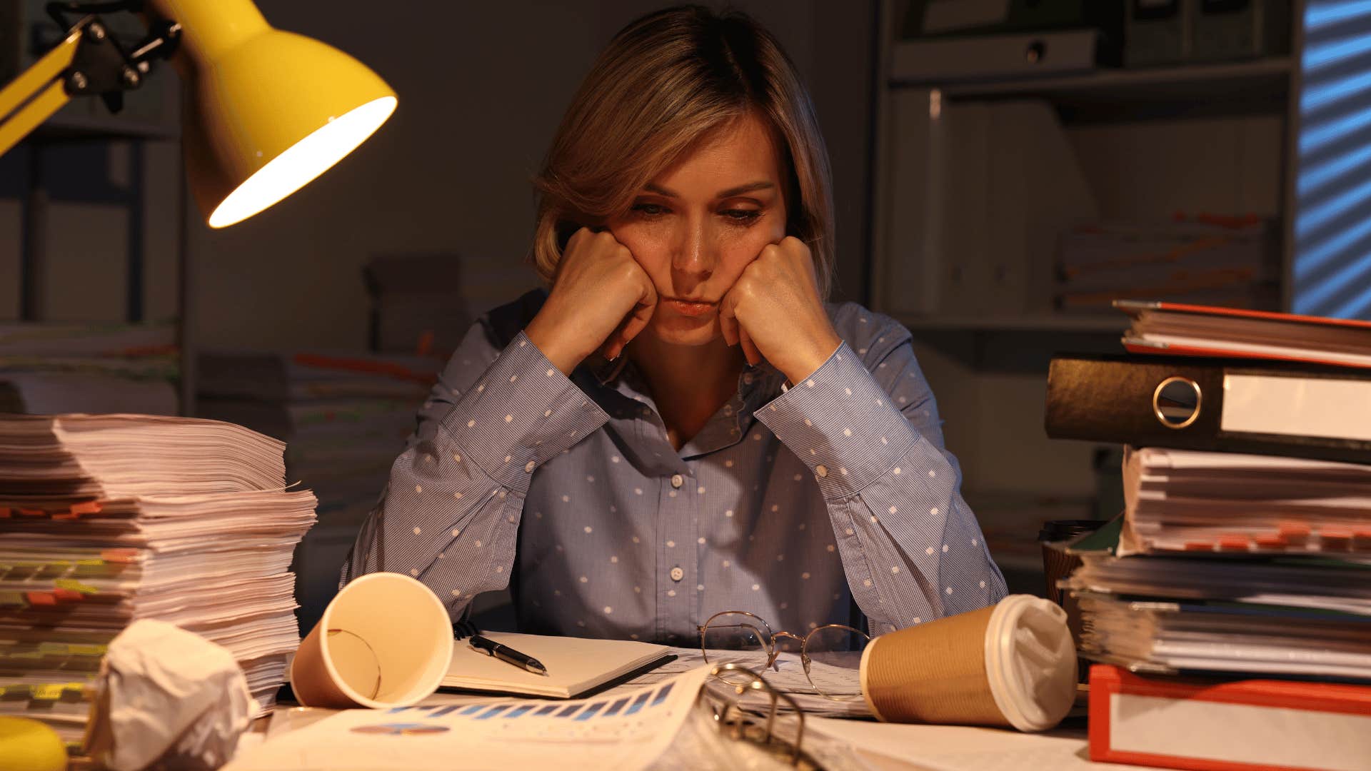 woman looking done with a pile of mess surrounding her 