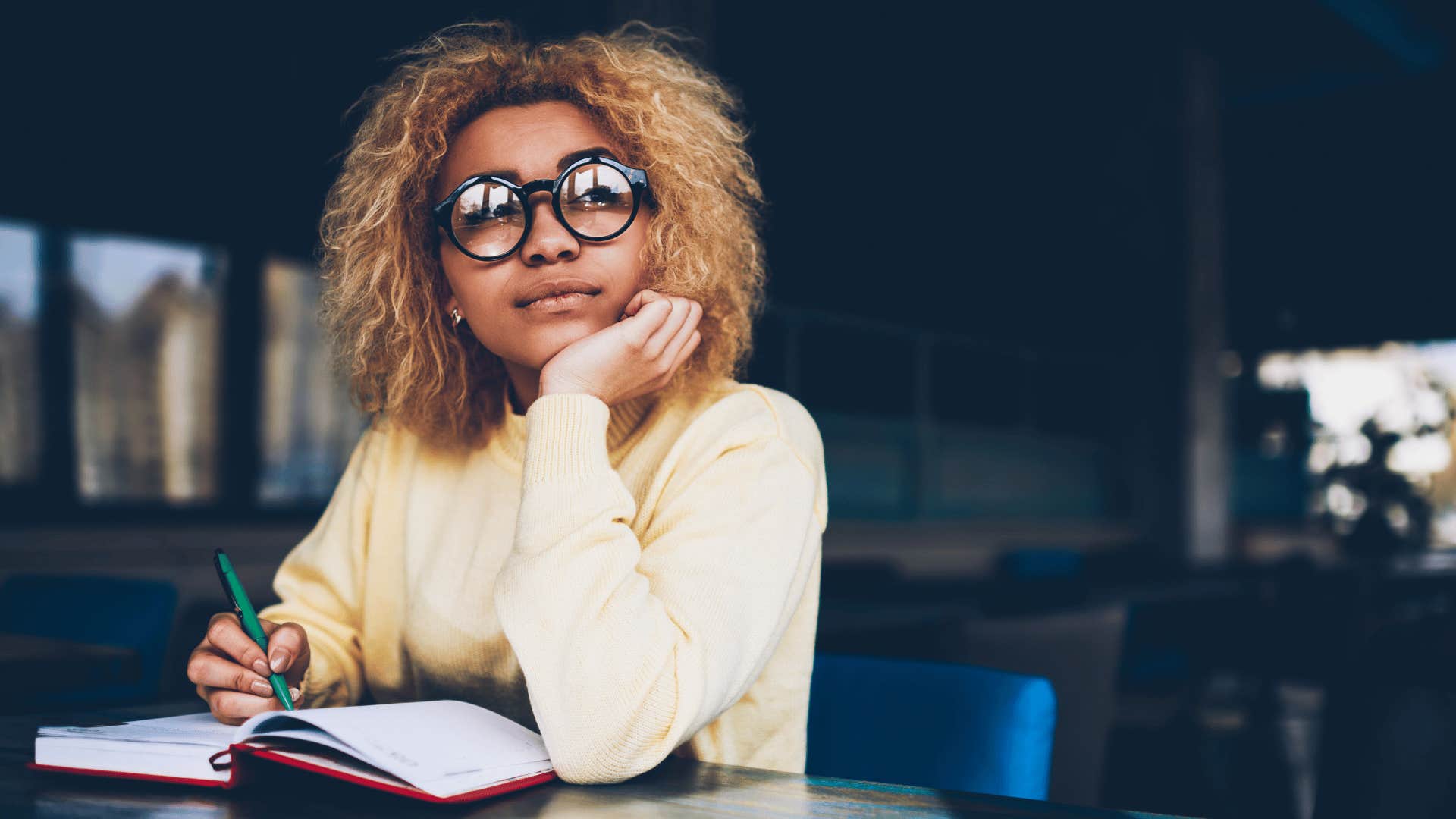 woman writing in journal 