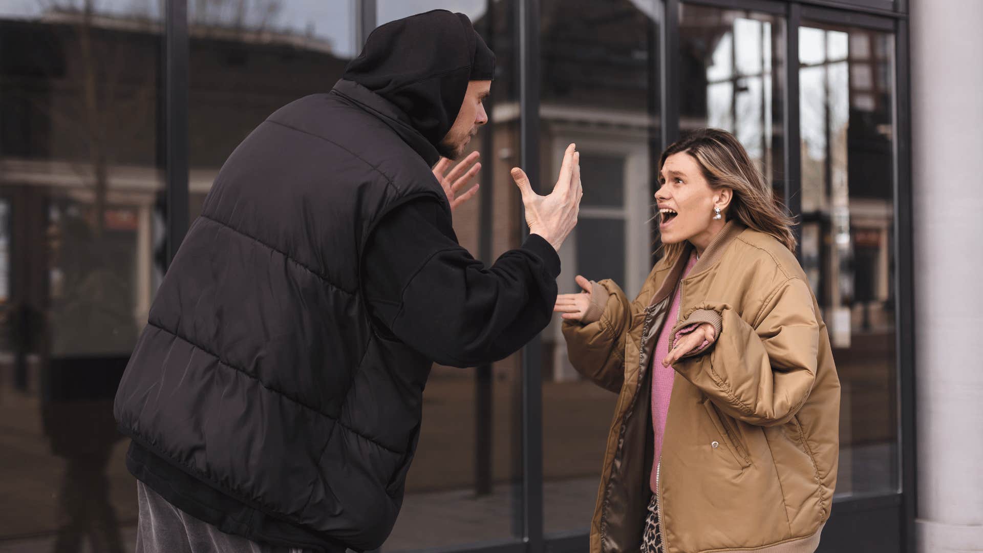 man and woman arguing outside