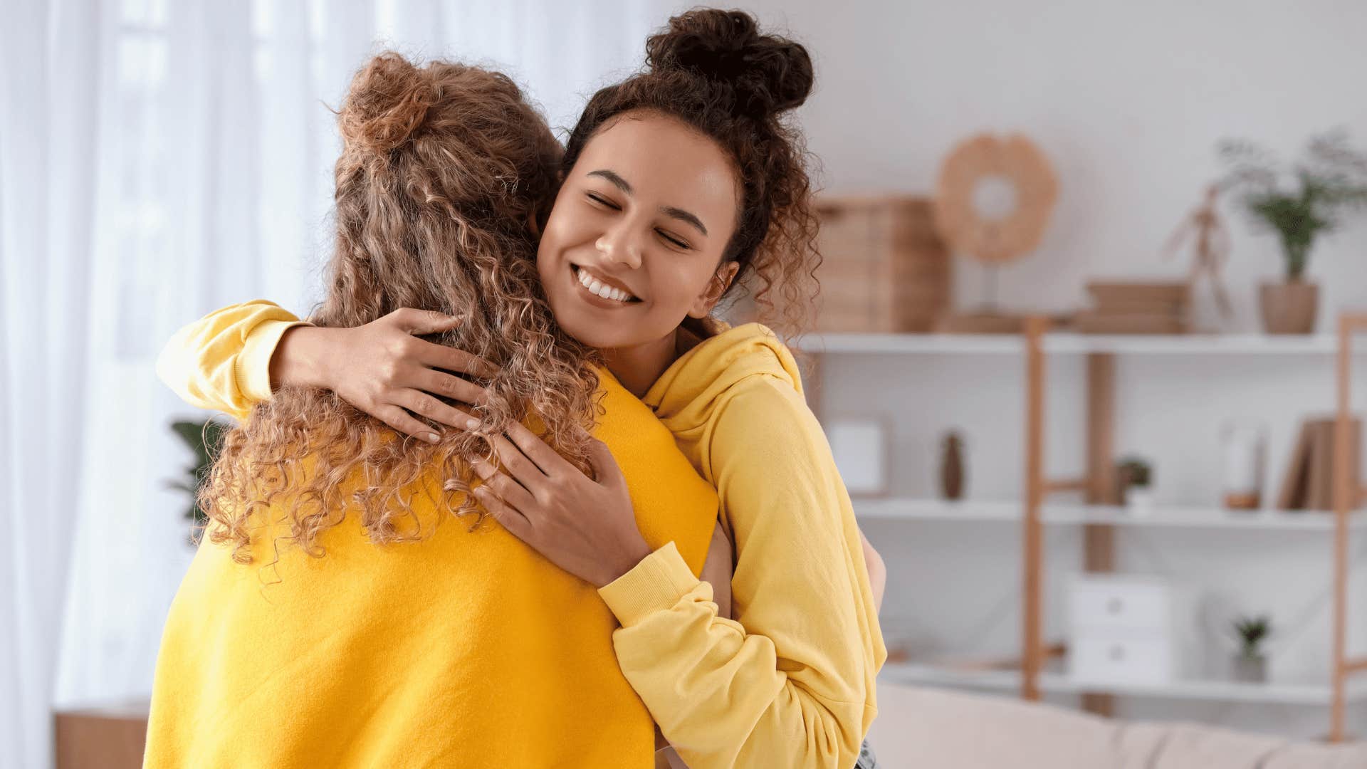 two women hugging and smiling 