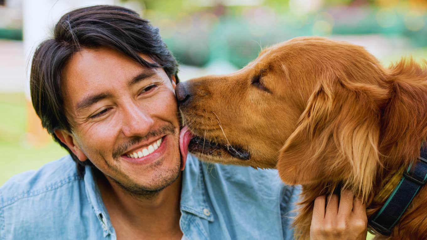 Man bonding with dog is smitten with a woman.