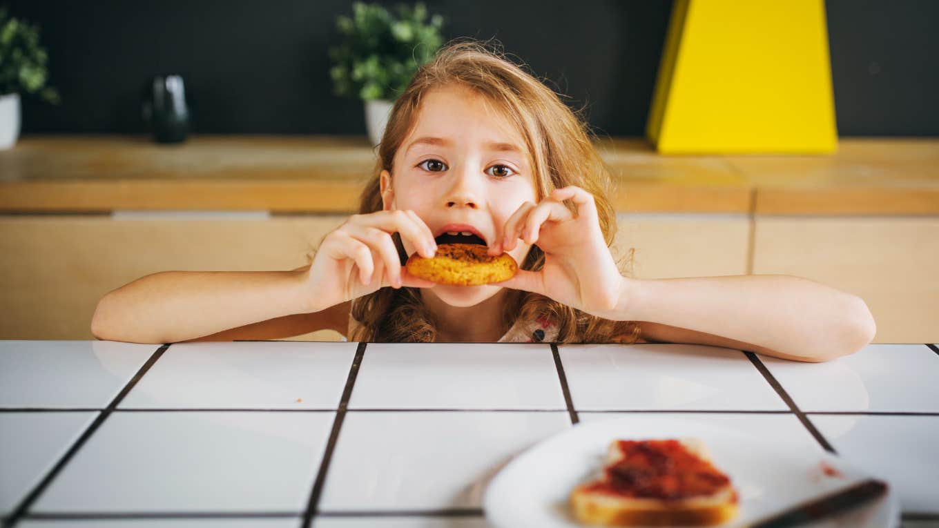 Young girl making herself a snack