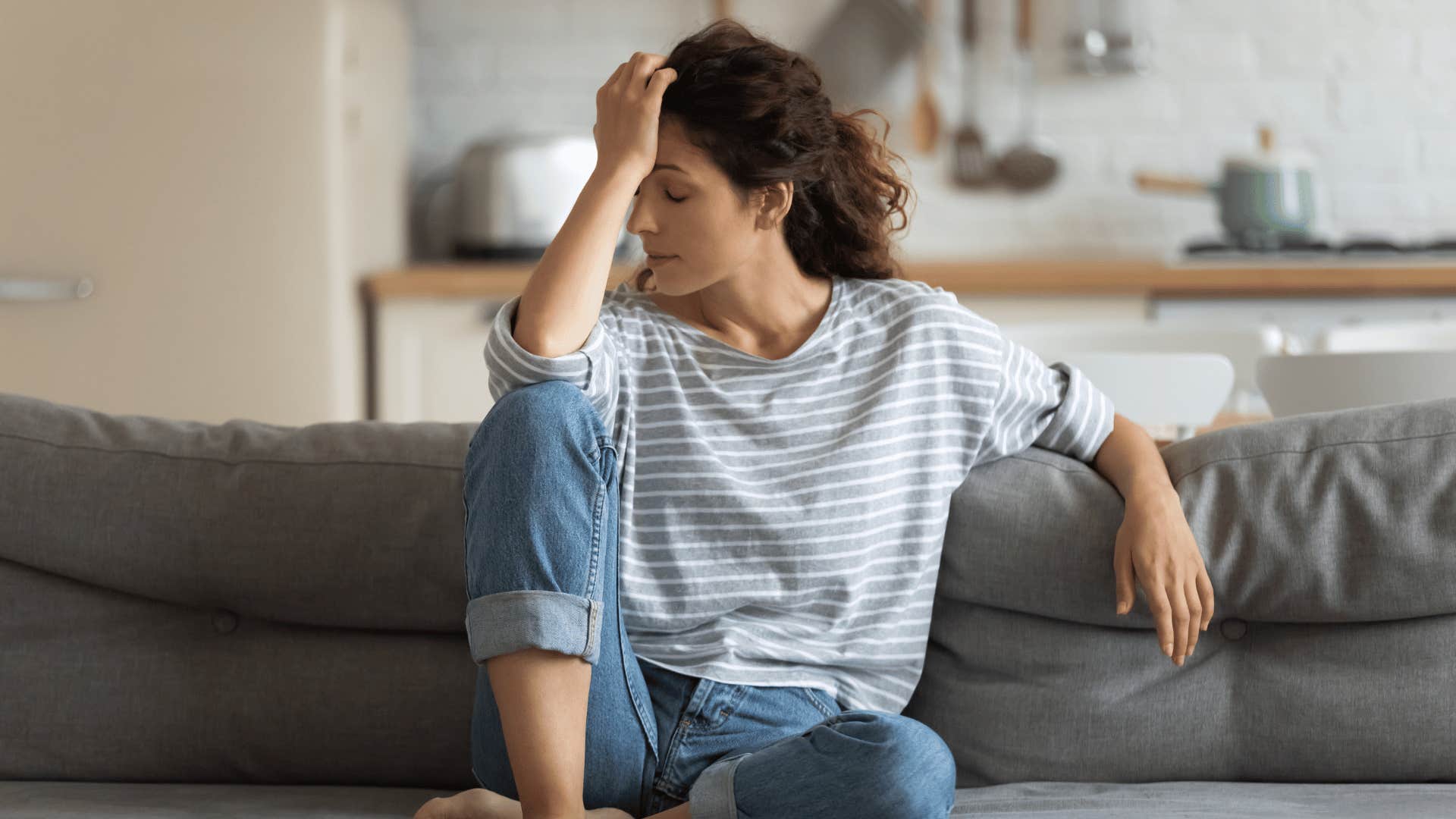 anxious woman on couch