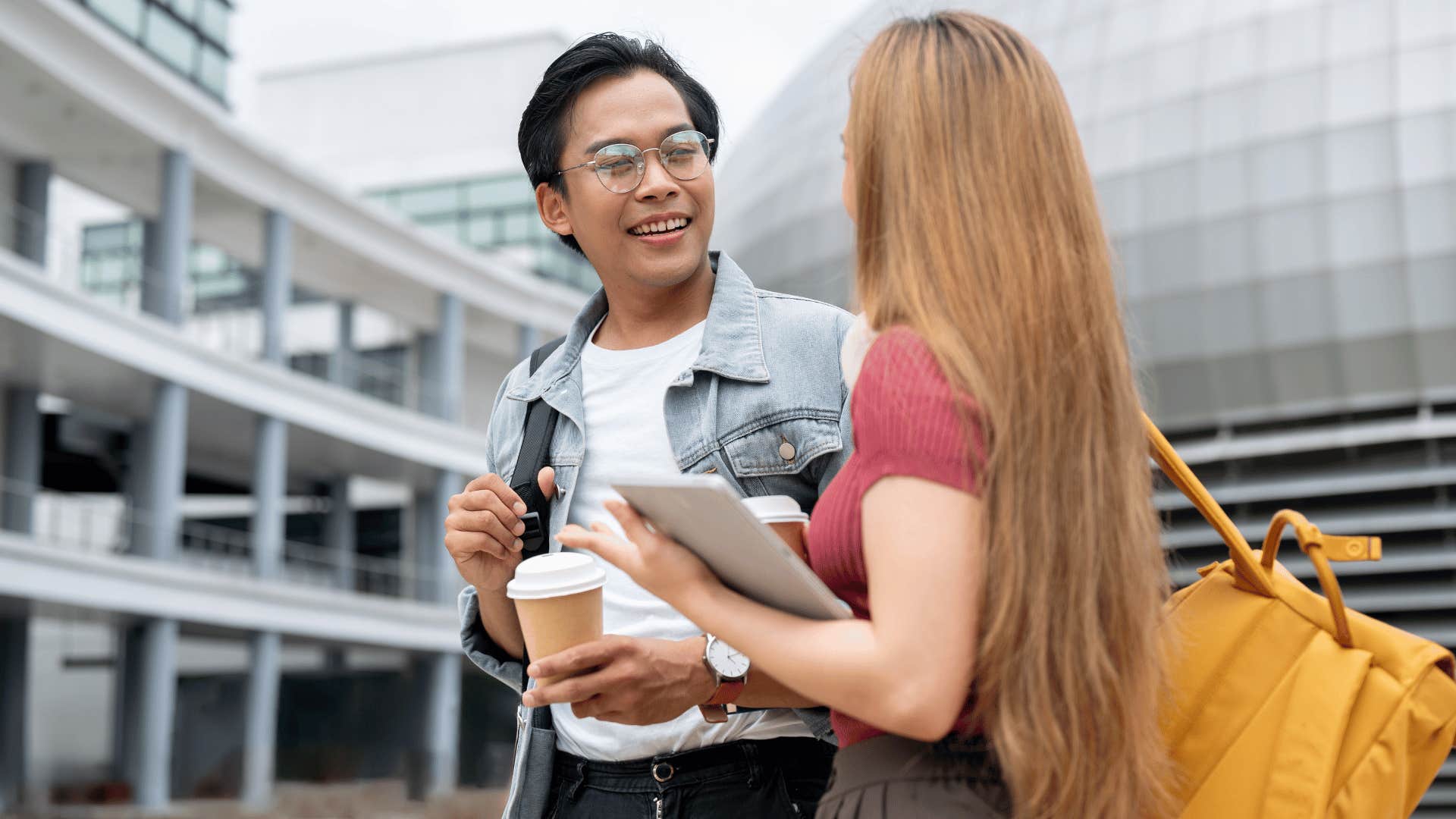 man listening to woman attentively while they walk 