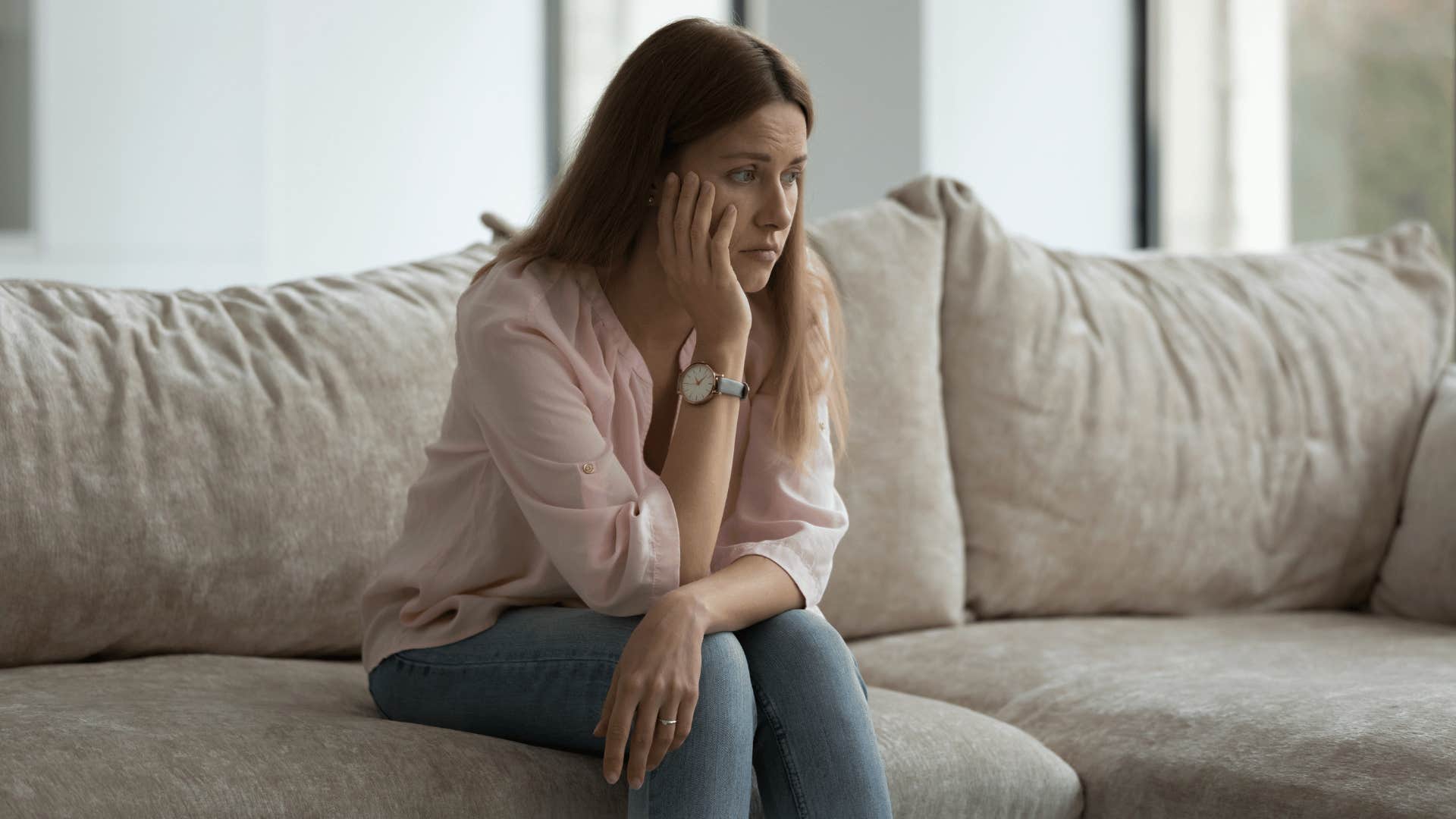 woman sitting alone on couch