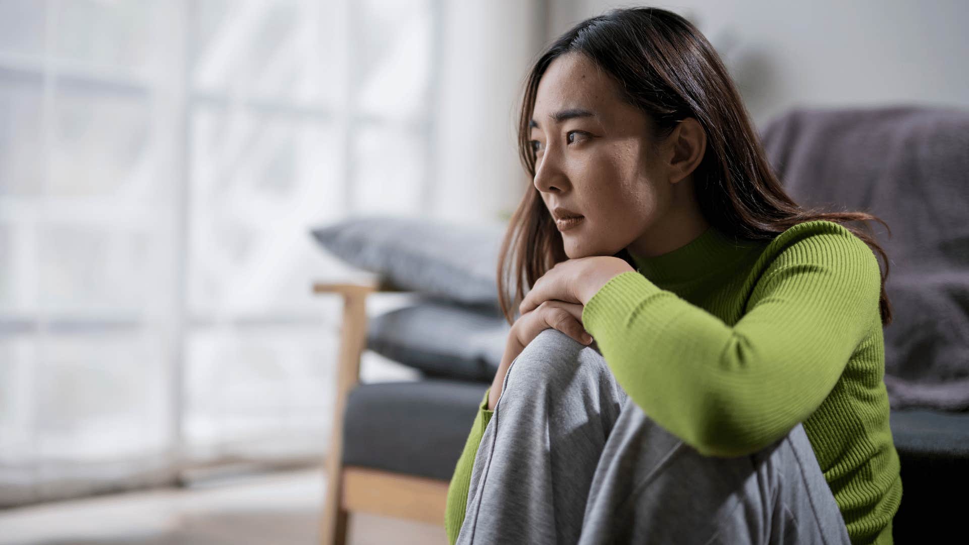 woman sitting down and looking ahead 