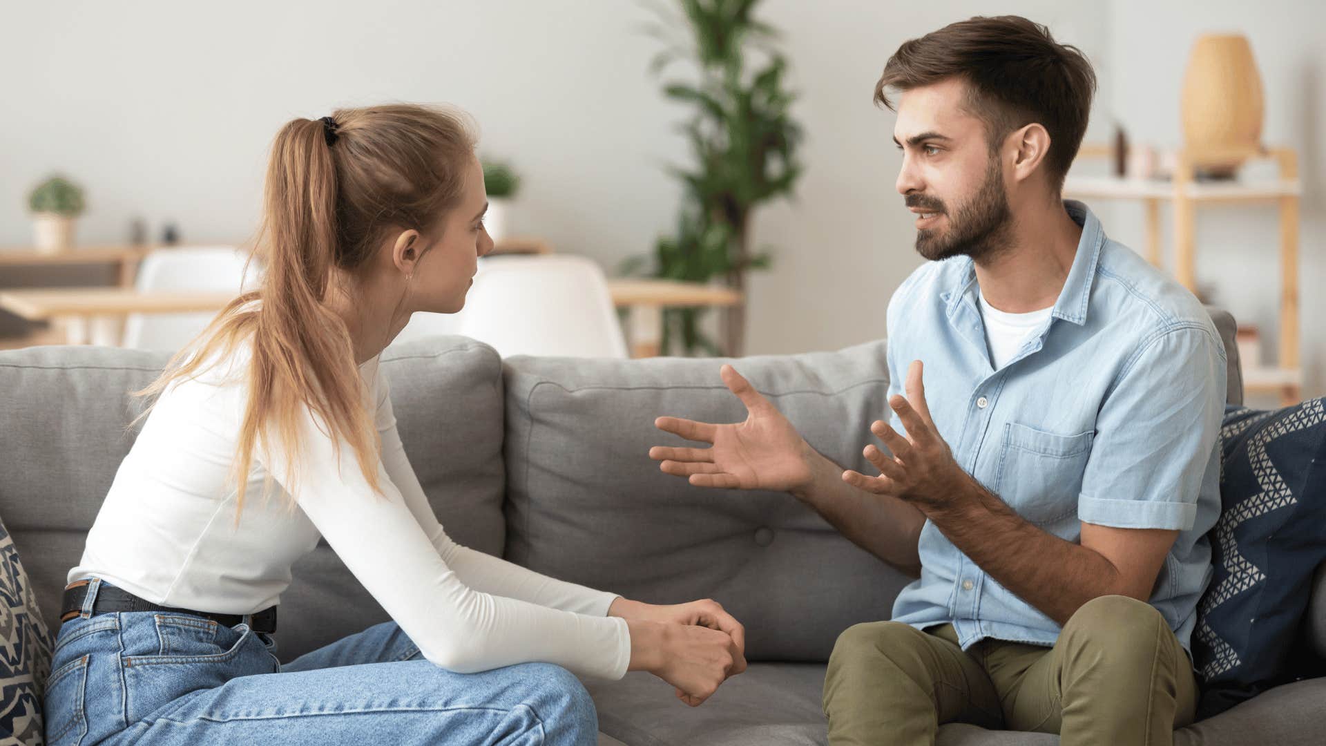 man having a serious conversation with woman while they both sit down