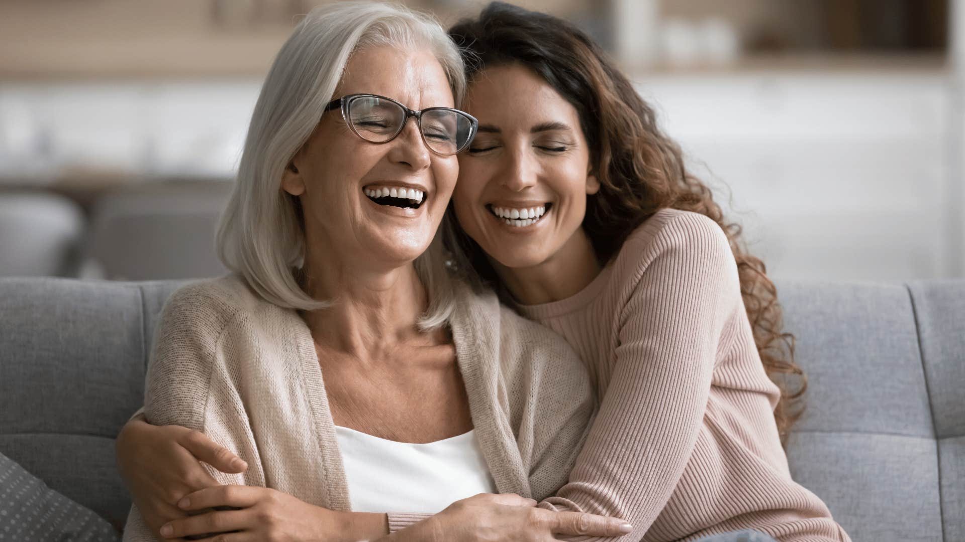 two women hugging and smiling 