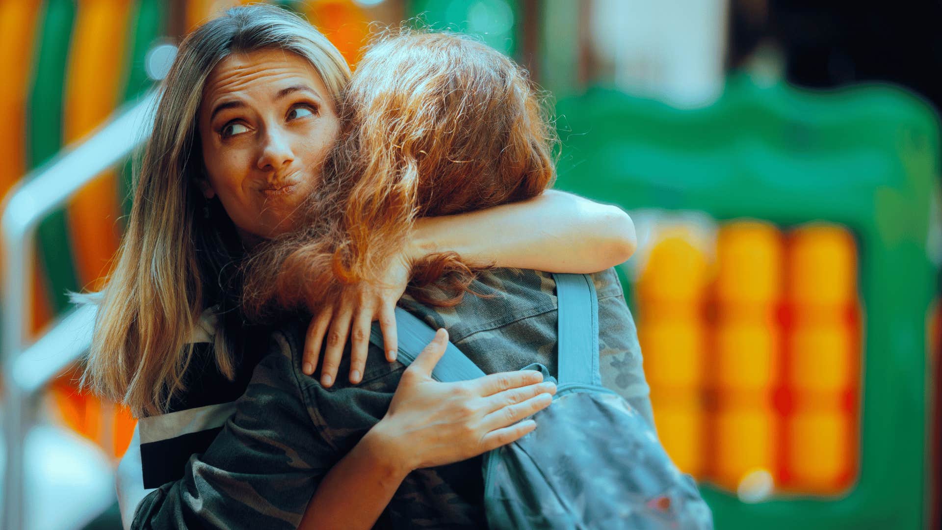 woman unhappily hugging friend 