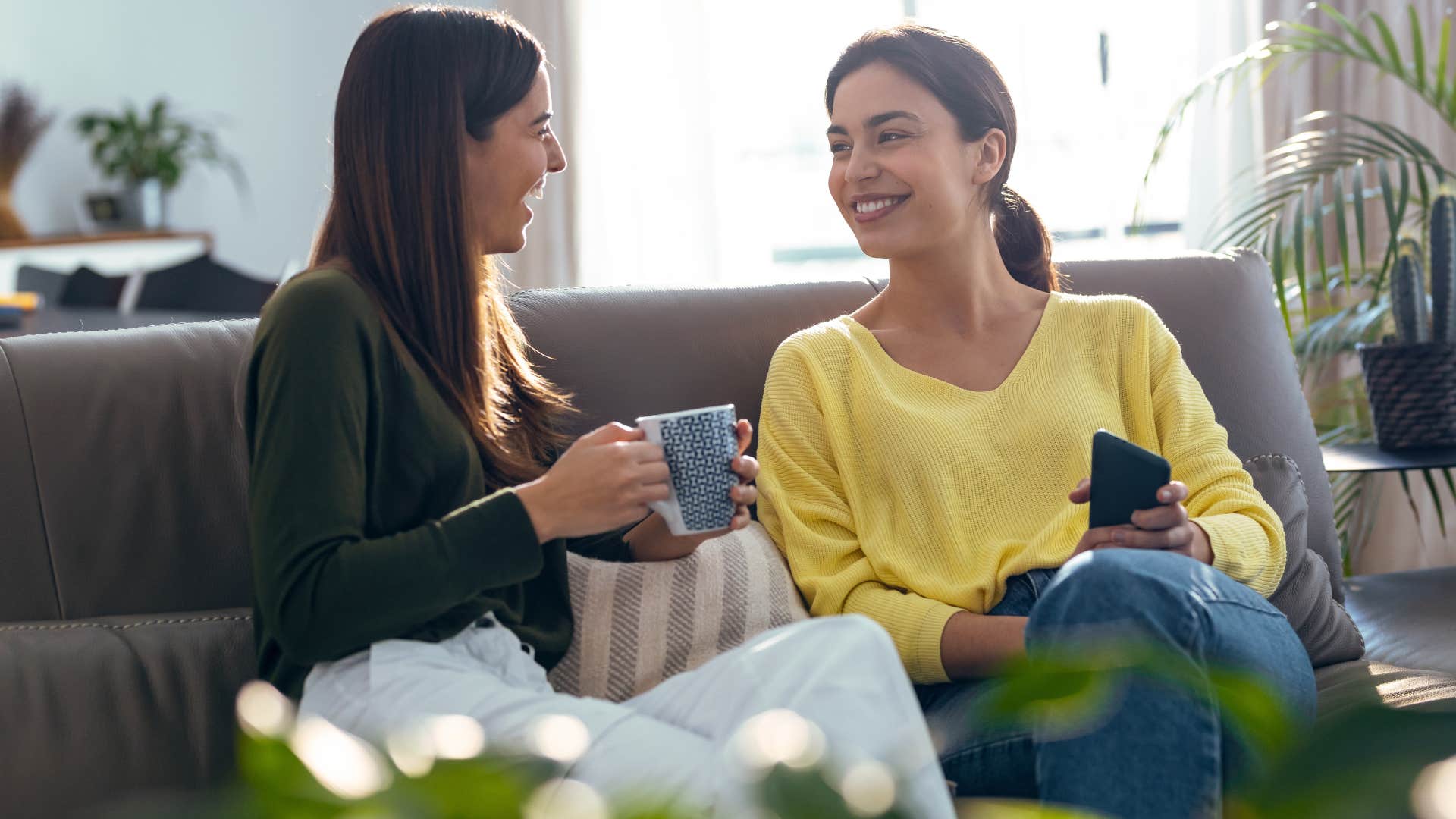 woman talking to friend on couch