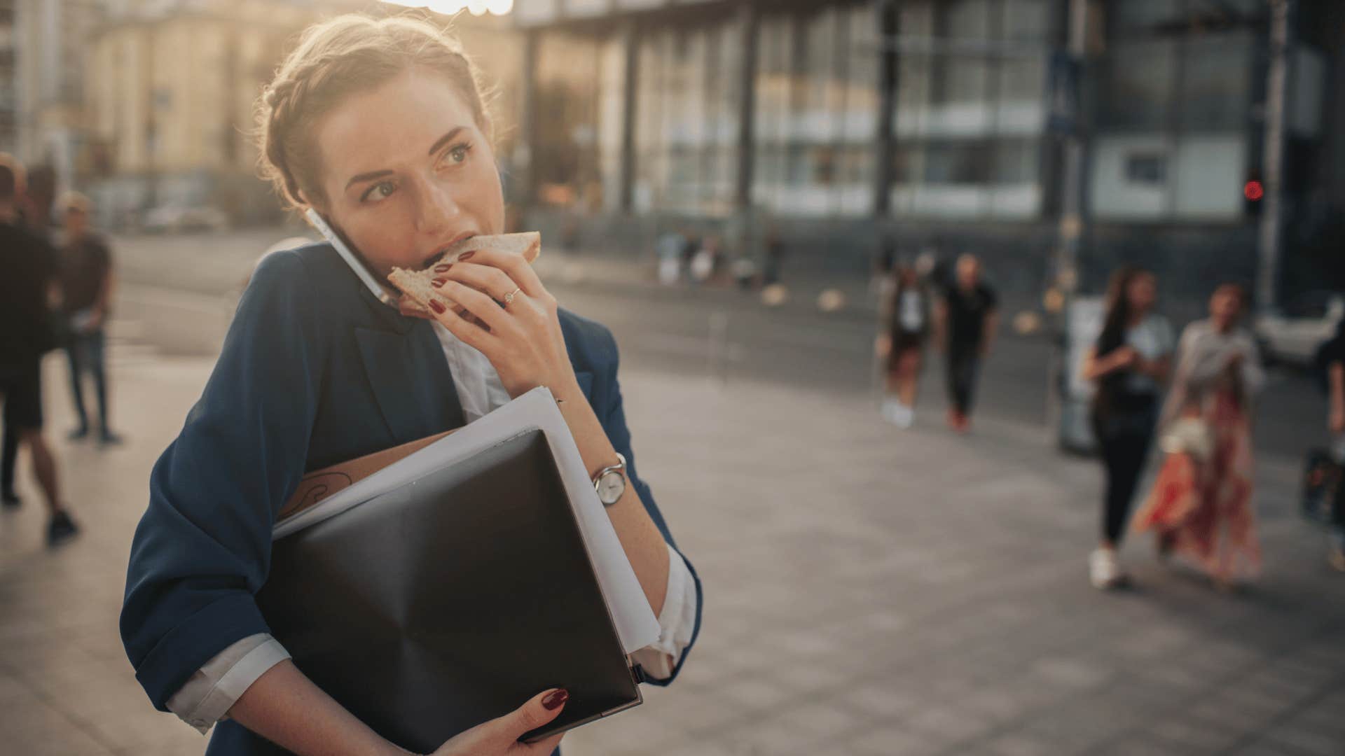 woman eating while walking to work