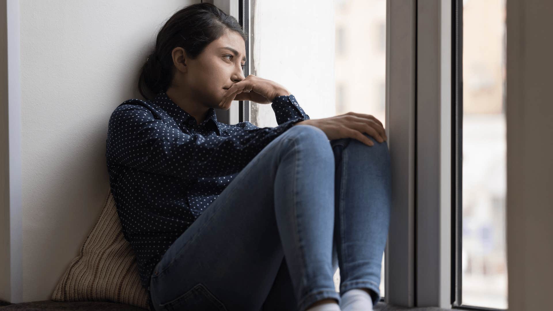 woman looking out window