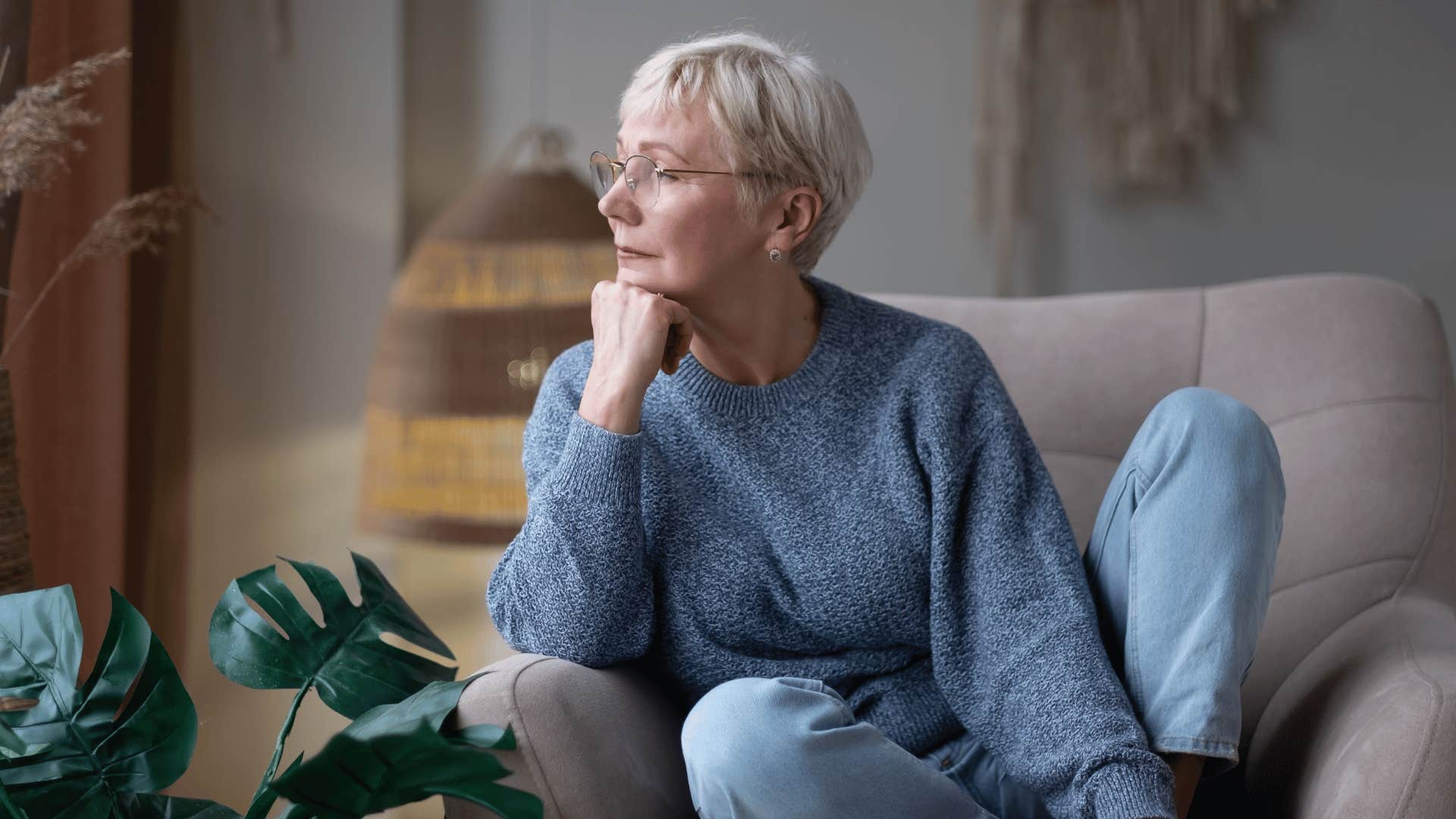 woman sitting while staring into space