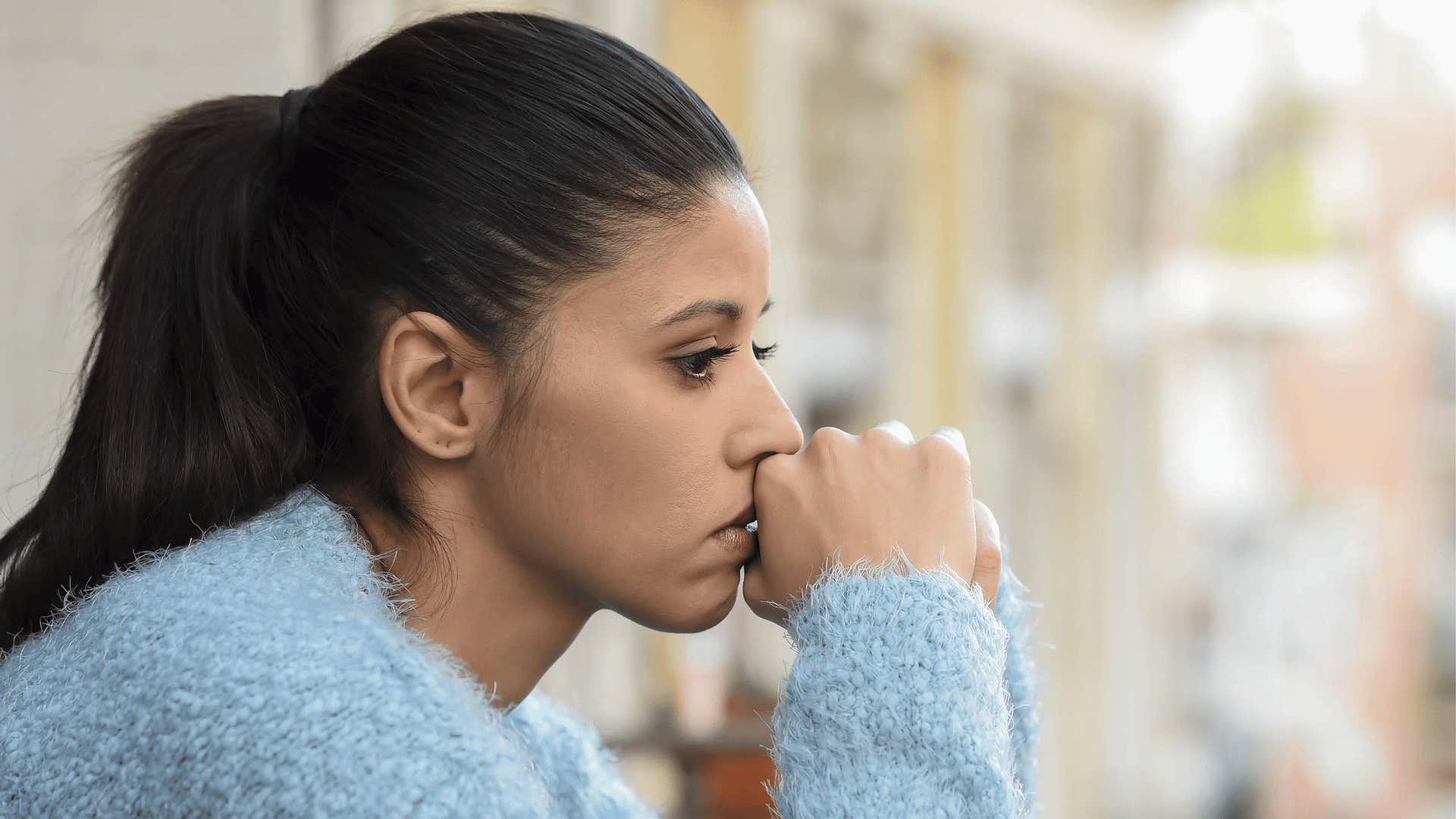 sad woman looking out window