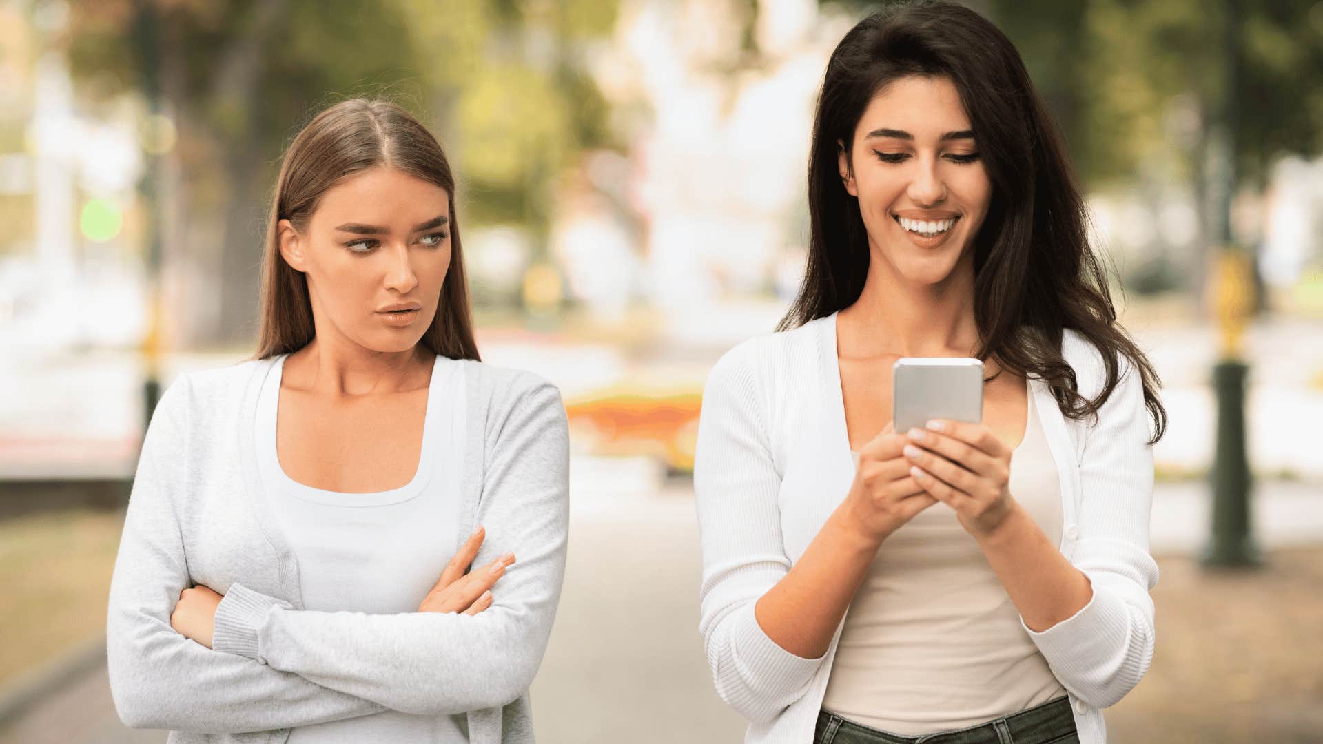 woman looking at other woman jealously 