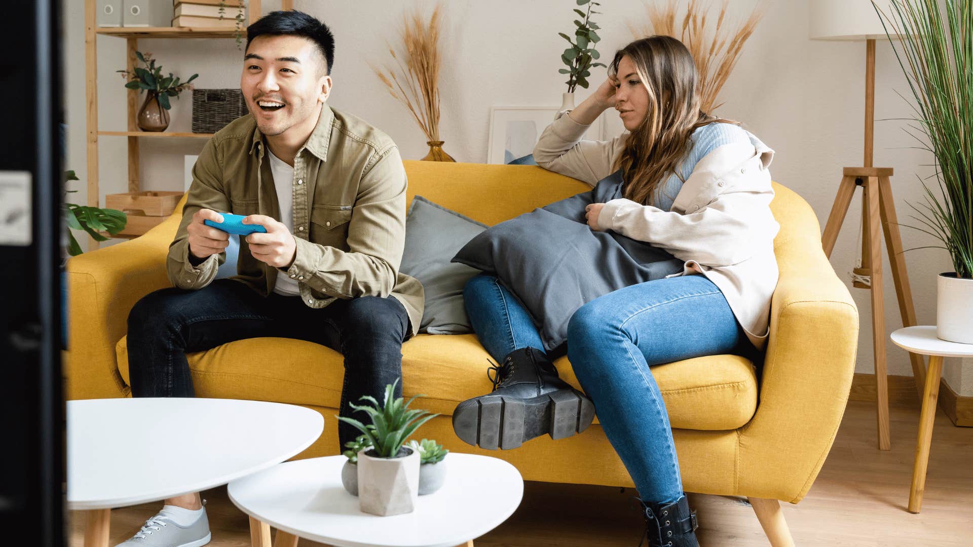 man playing video games ignoring partner 