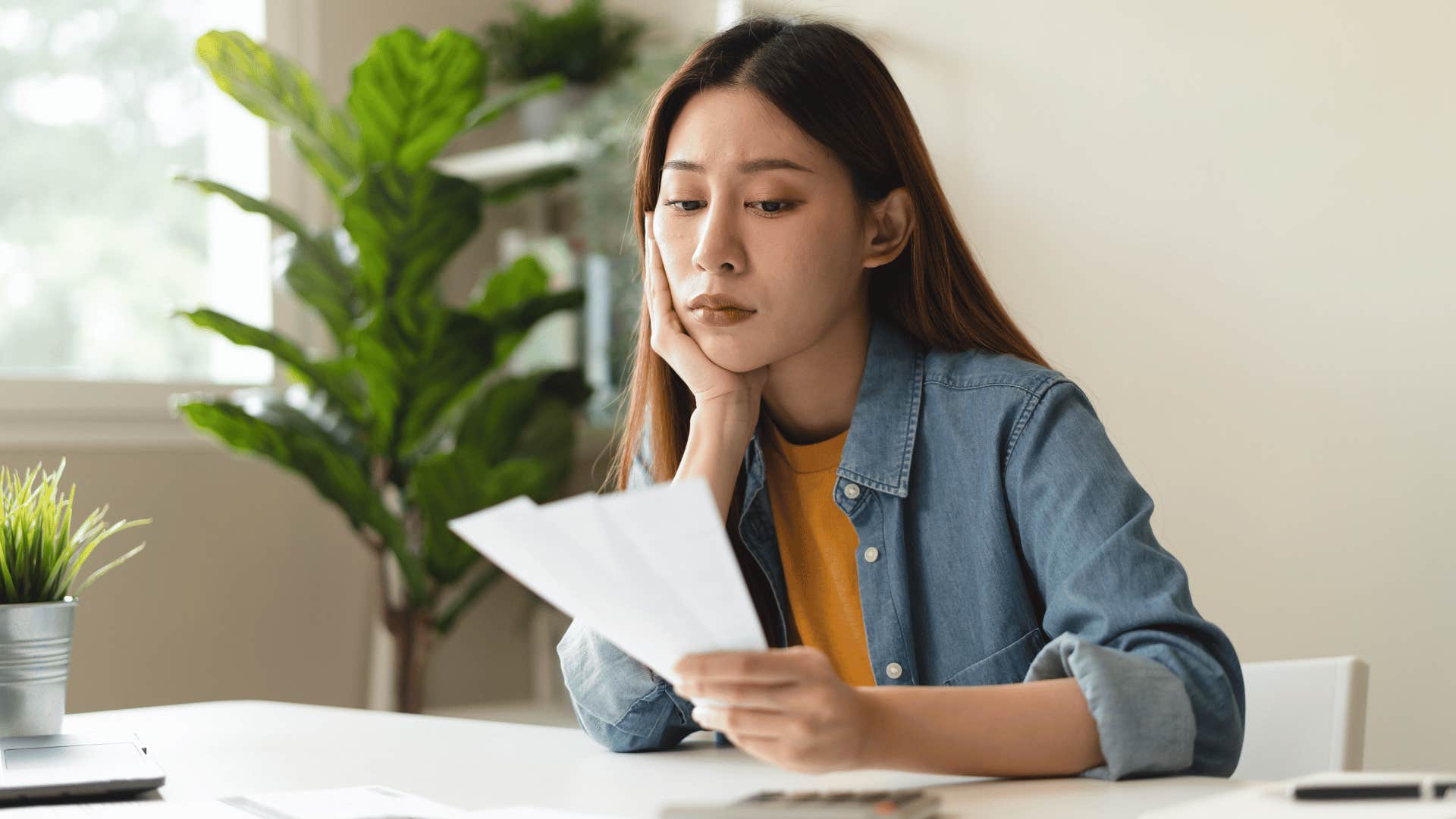 woman looking at bills