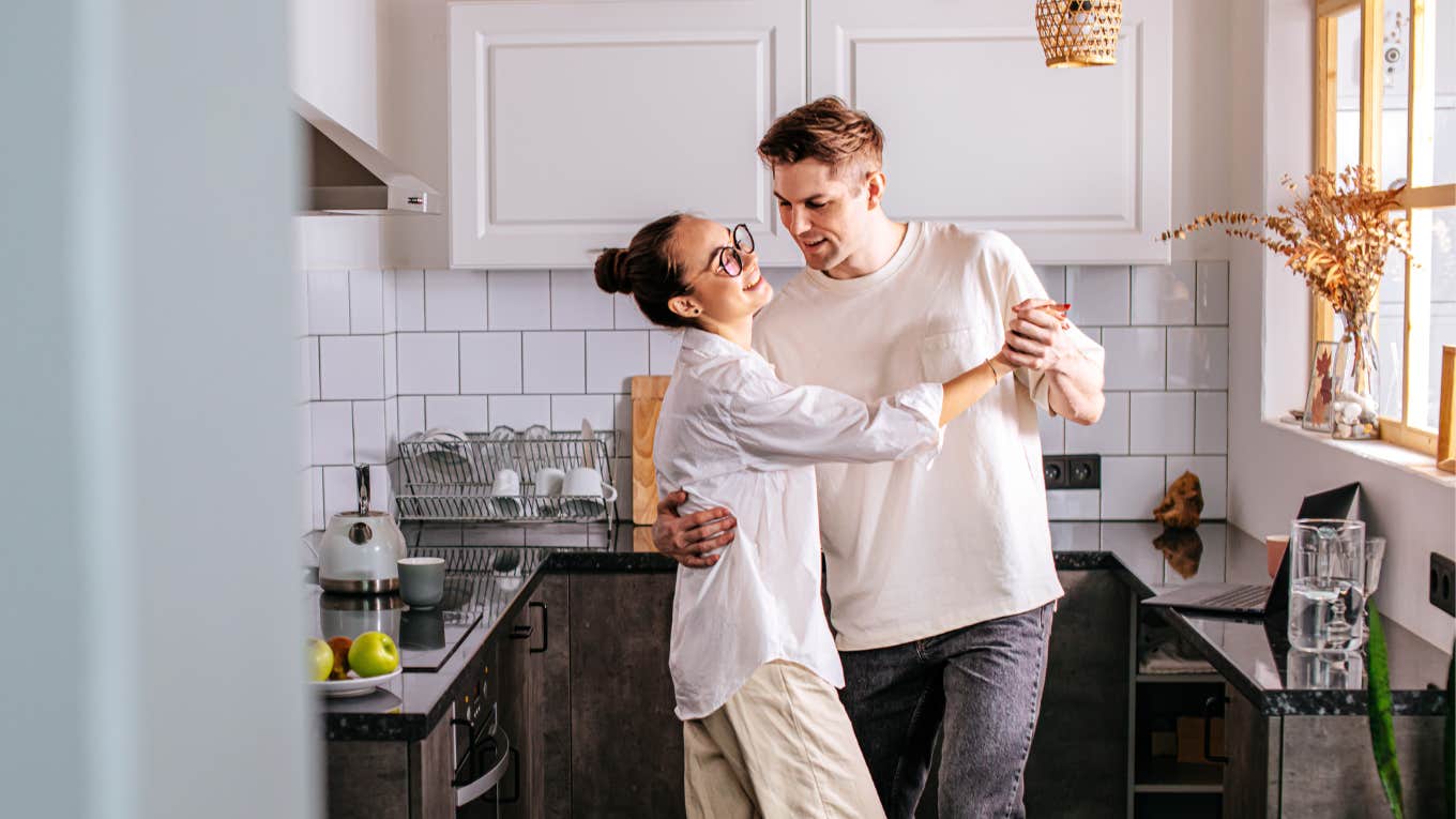 Married couple sharing small glimmer together in kitchen