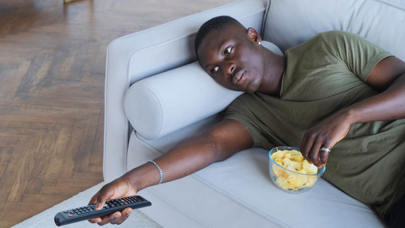 Man watching Disney movies and eating chips