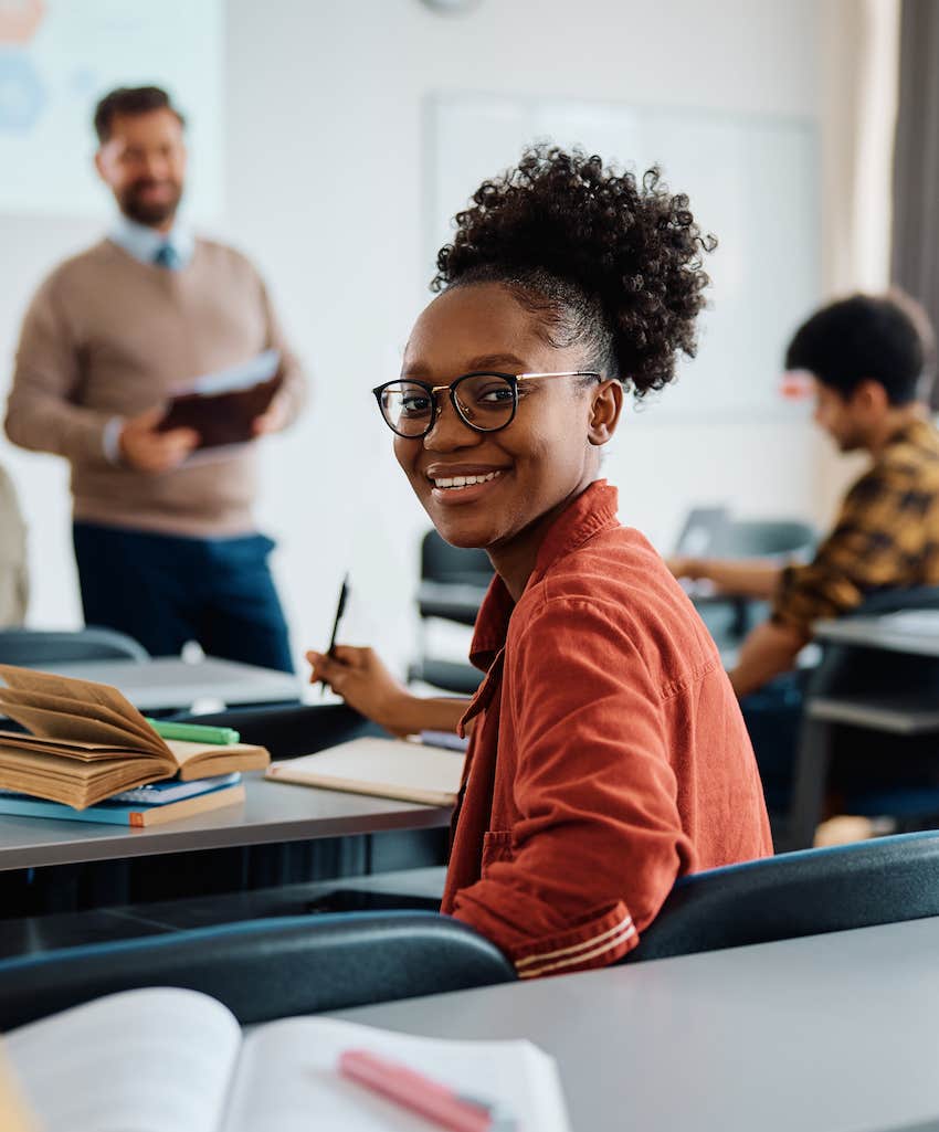 She turns to talk to you in a classroom