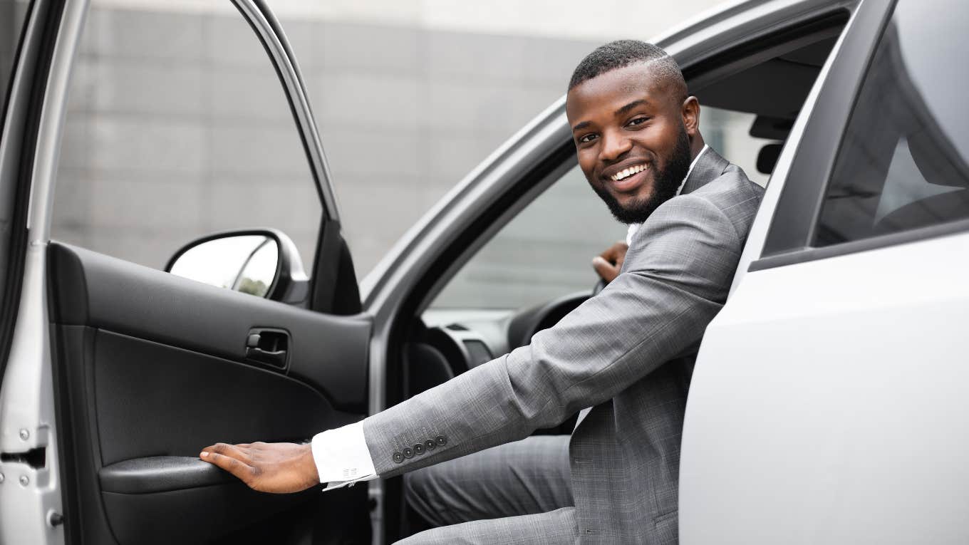 man getting into new car