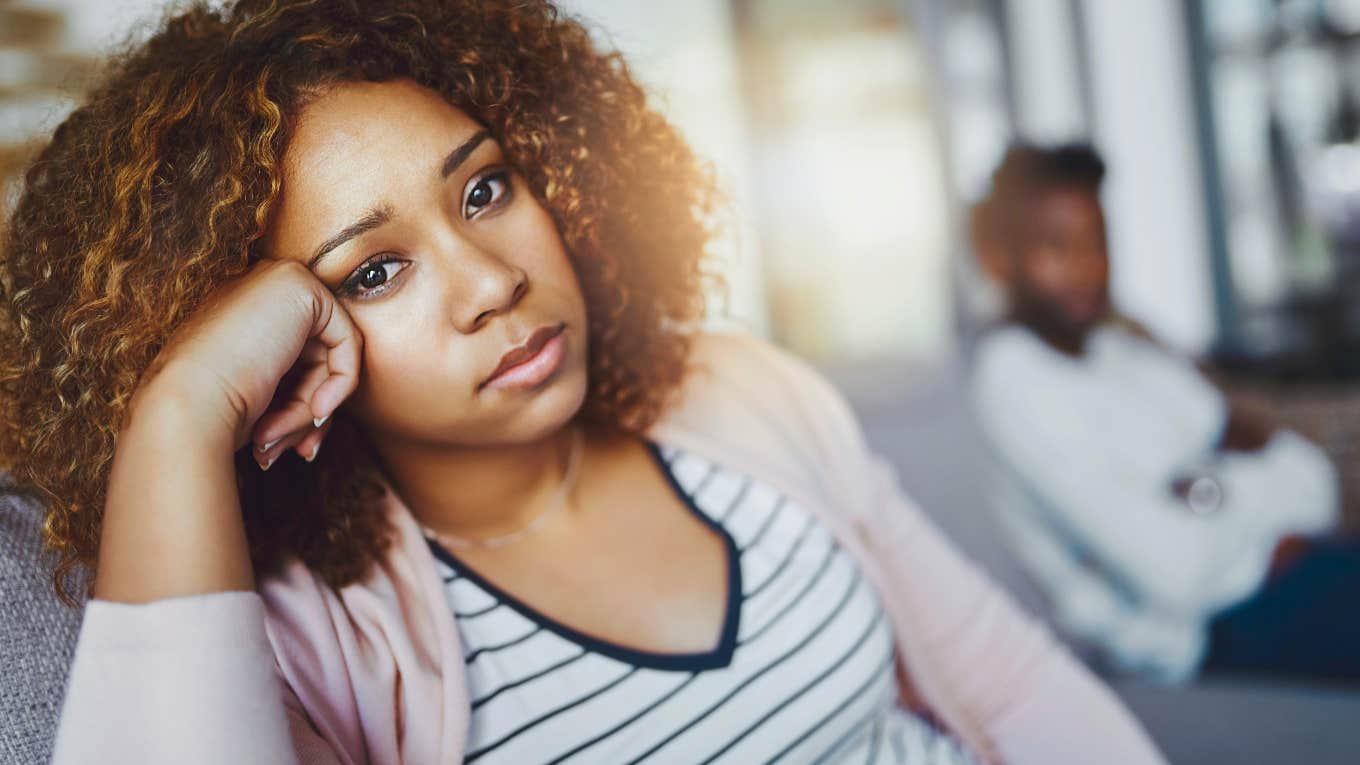 woman ignoring someone on the couch