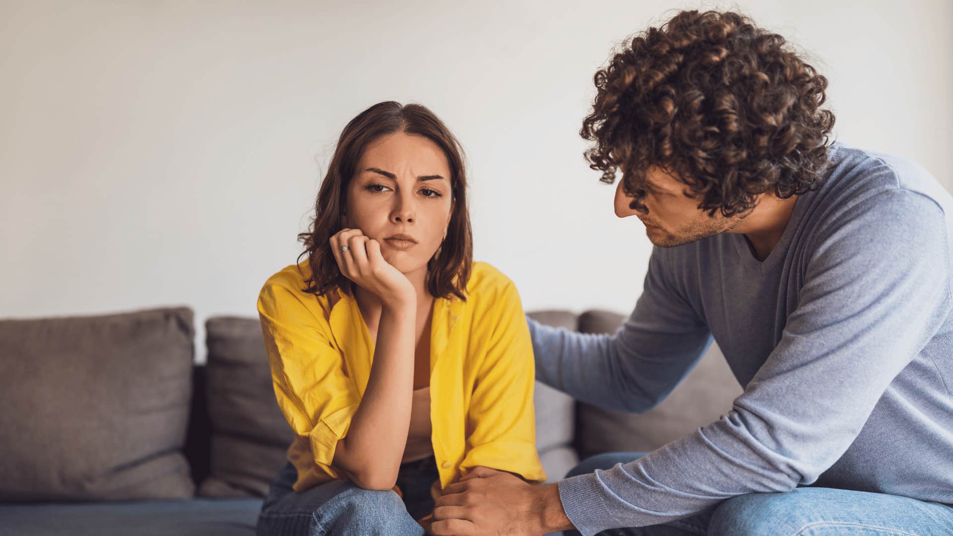 bored woman sitting with boyfriend