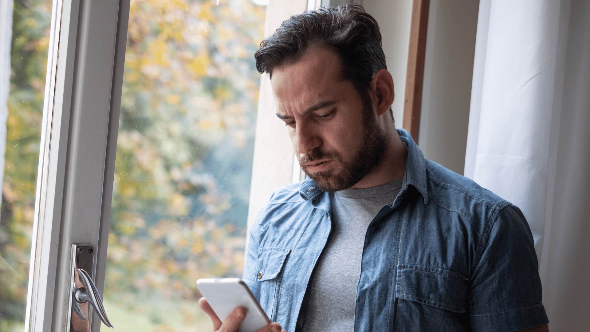 man looking at his phone