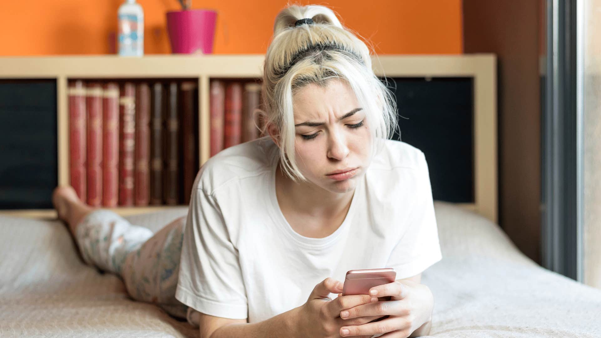 sad woman looking at phone