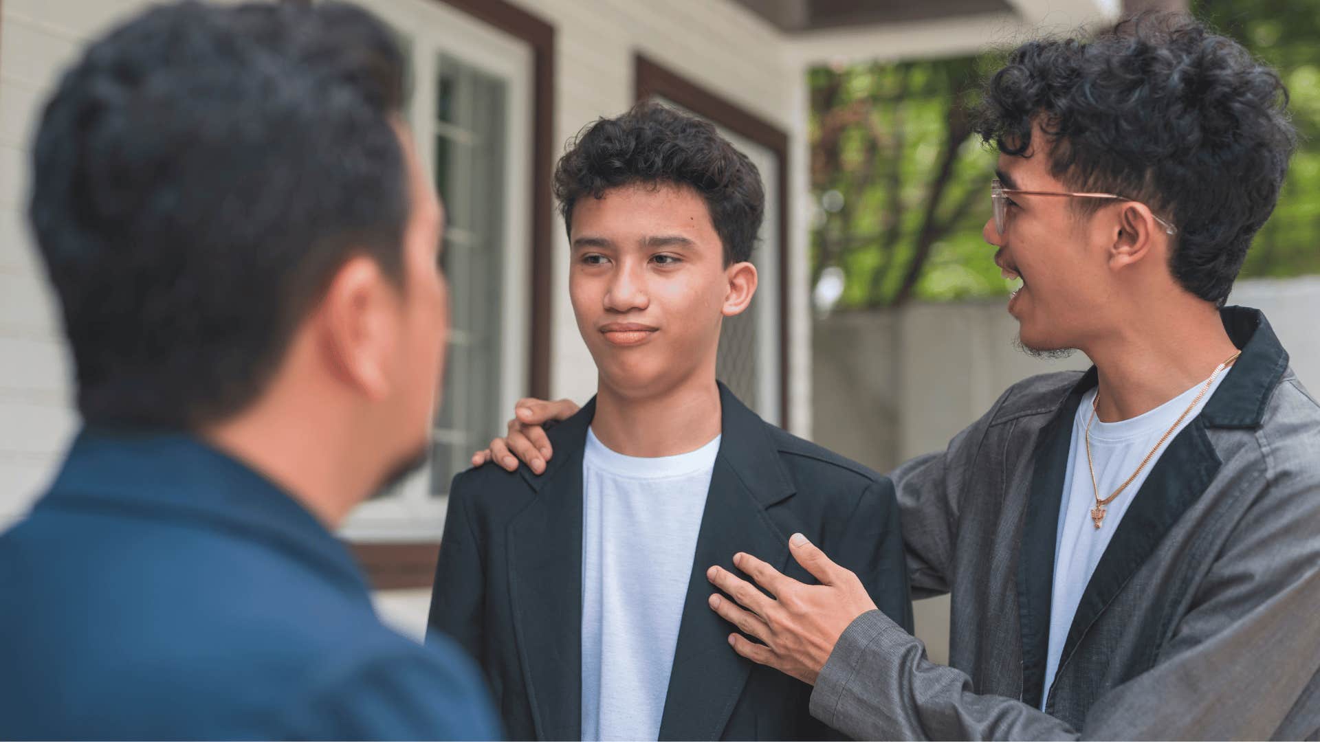 man awkwardly introducing his friend to other man