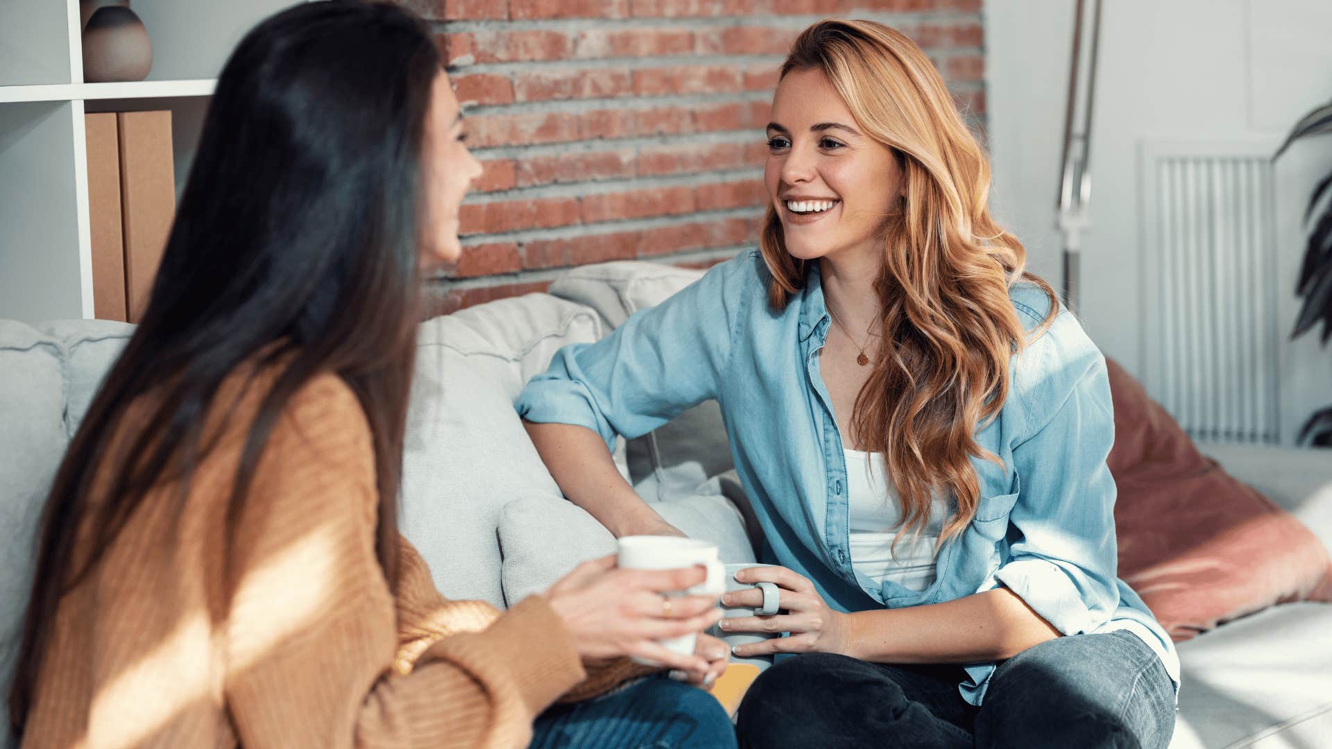 two women chatting on sofa