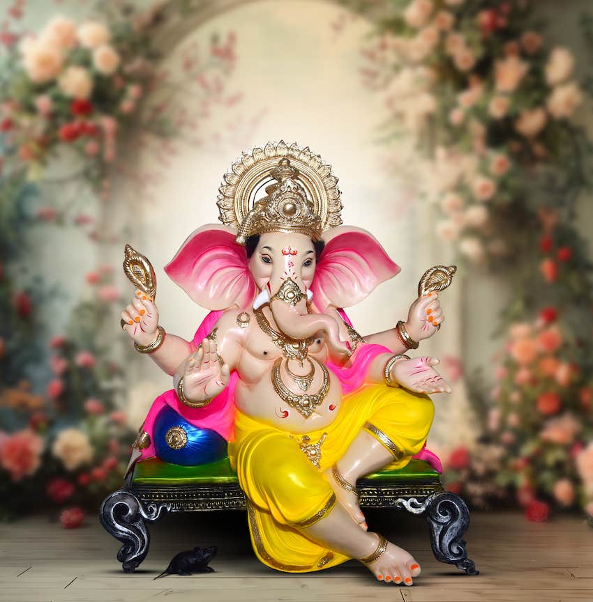 Lord Ganesha with artificial flowers decoration background