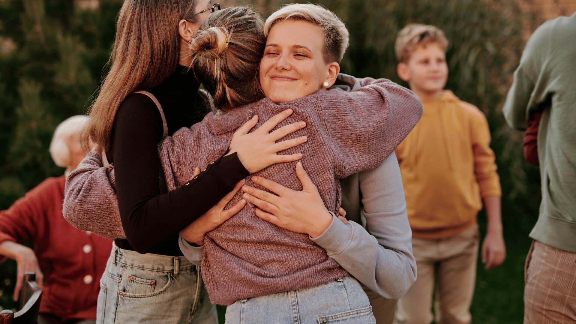 mom hugging adult children