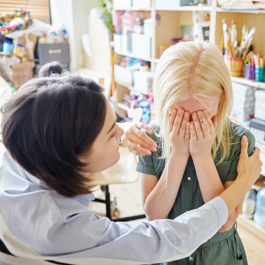 Teacher comforting crying student