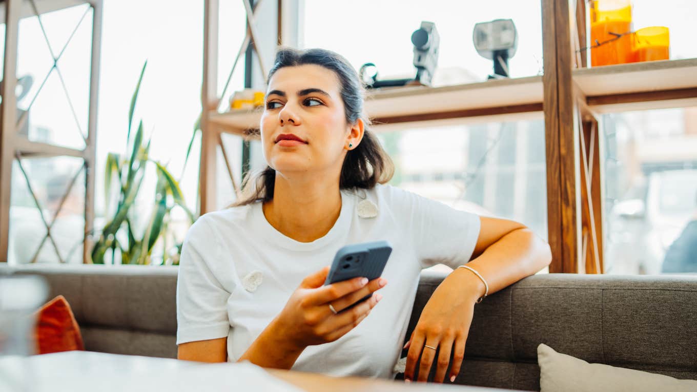 Woman debating if she should text a guy she likes back