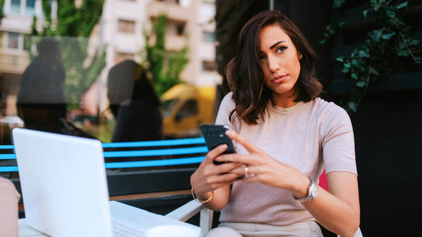 Angry woman deciding if she should text her partner