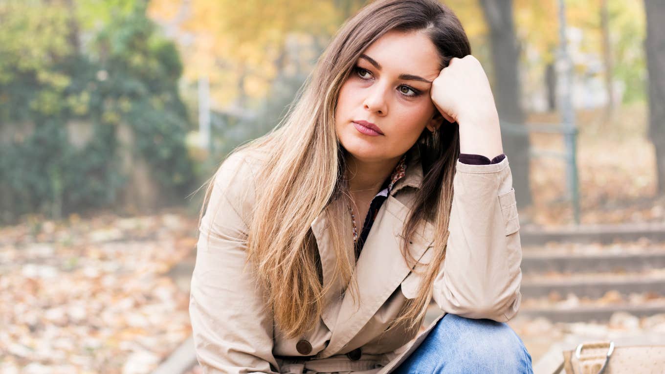 Woman looking sad while thinking about her sad parents. 