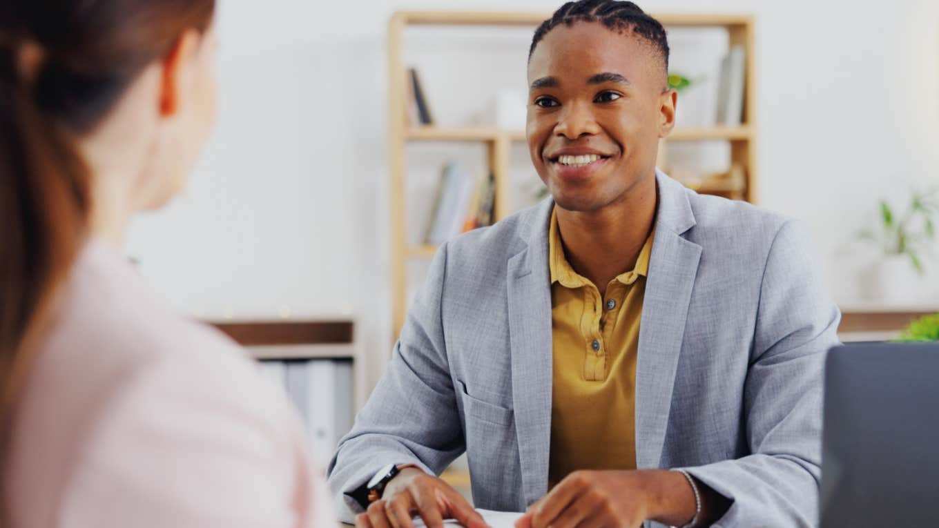 Employee smiling with coworker starting a new job. 