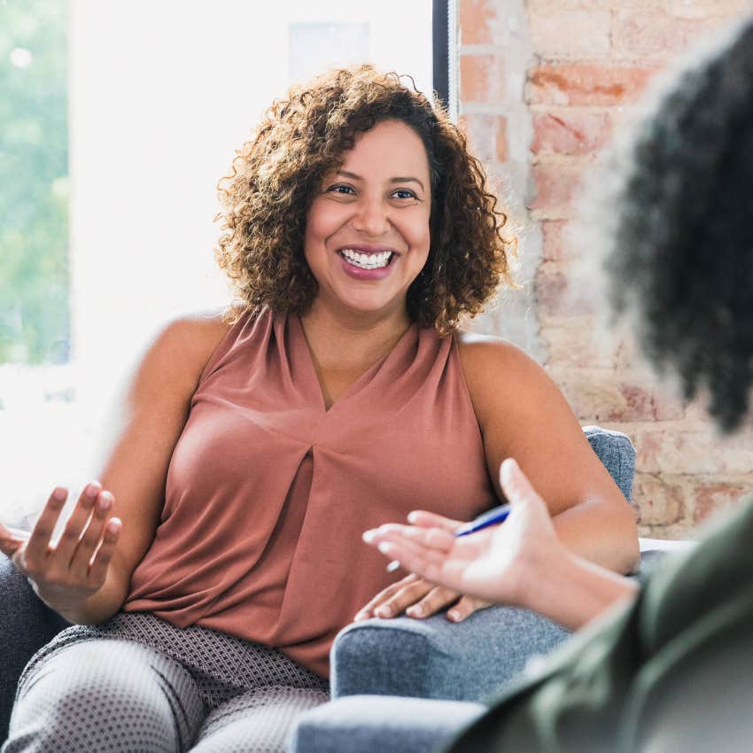 Mentally tough woman smiling in therapy session. 