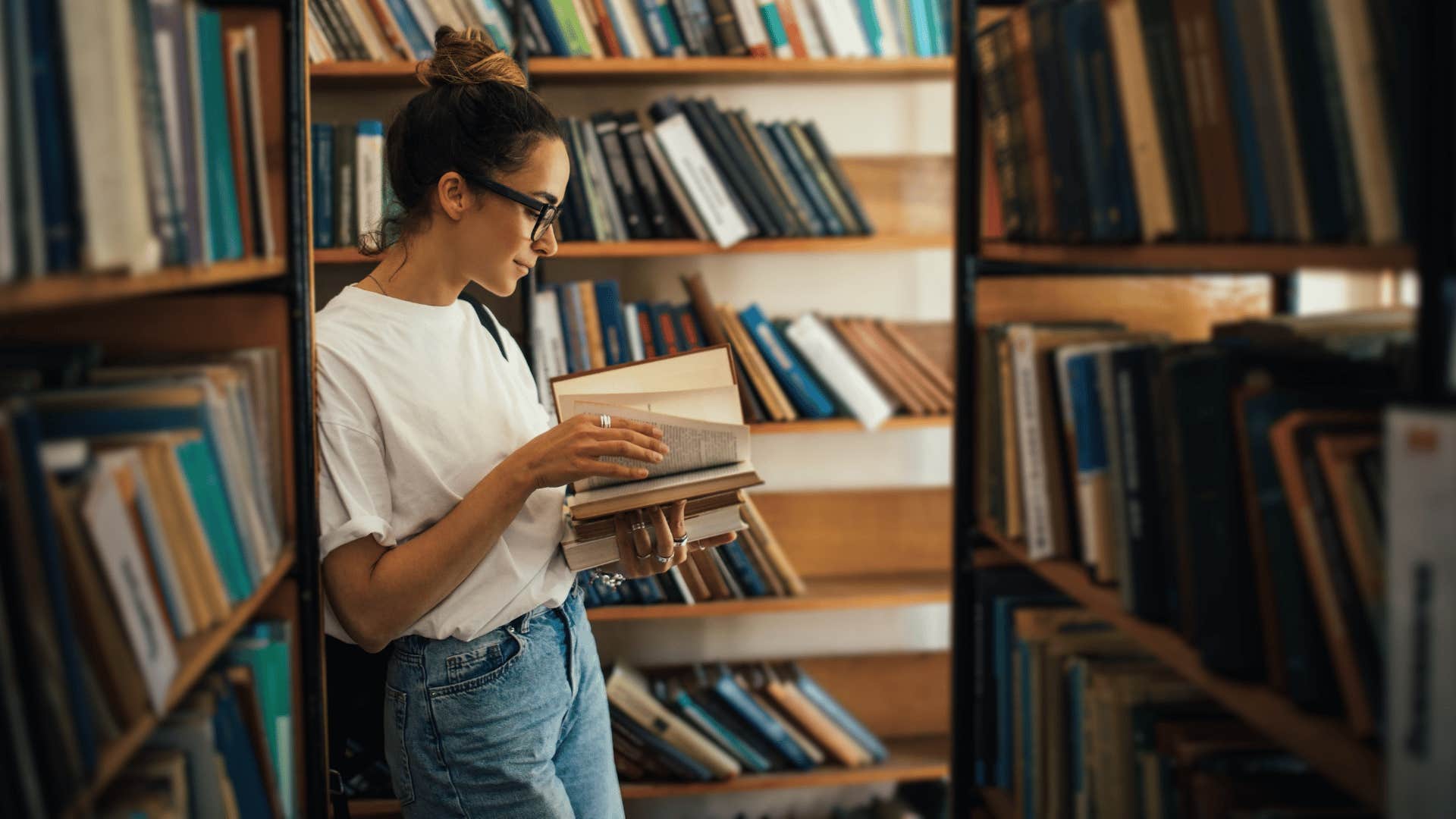 woman reading book in library 