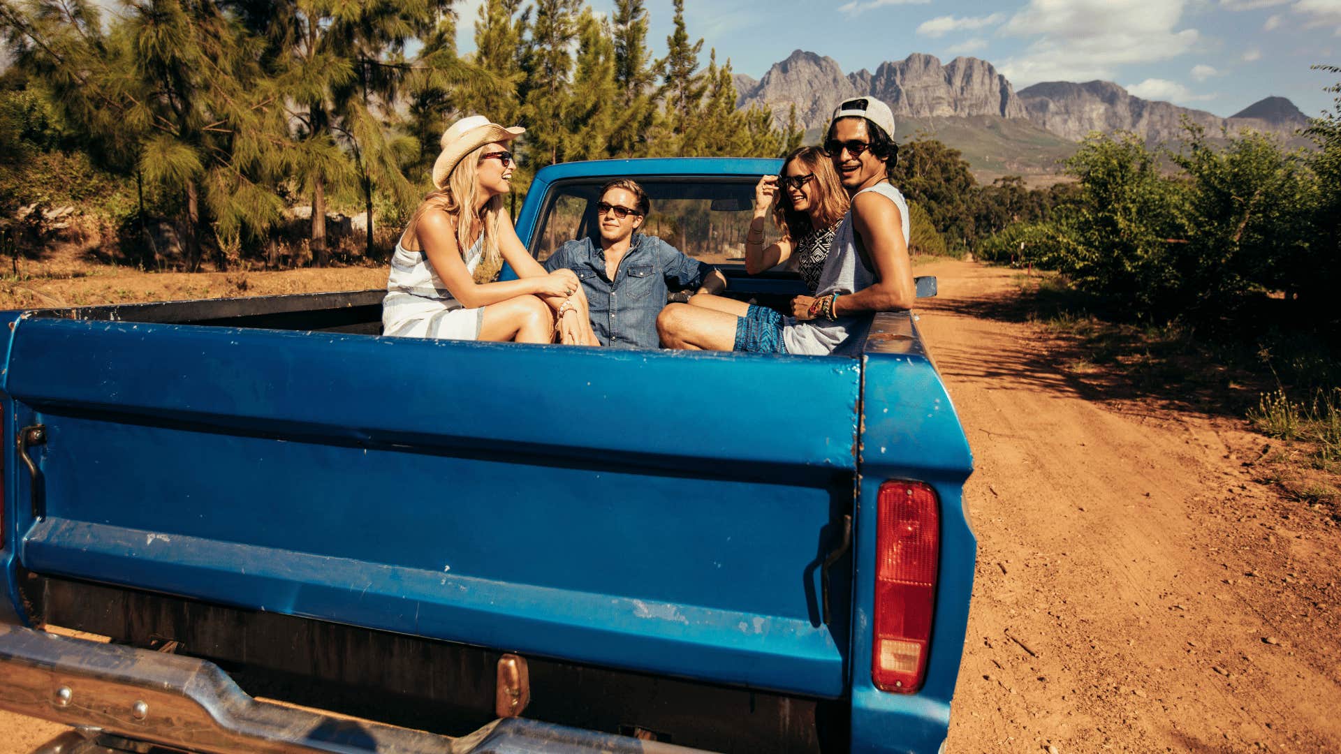 friends riding in back of a truck