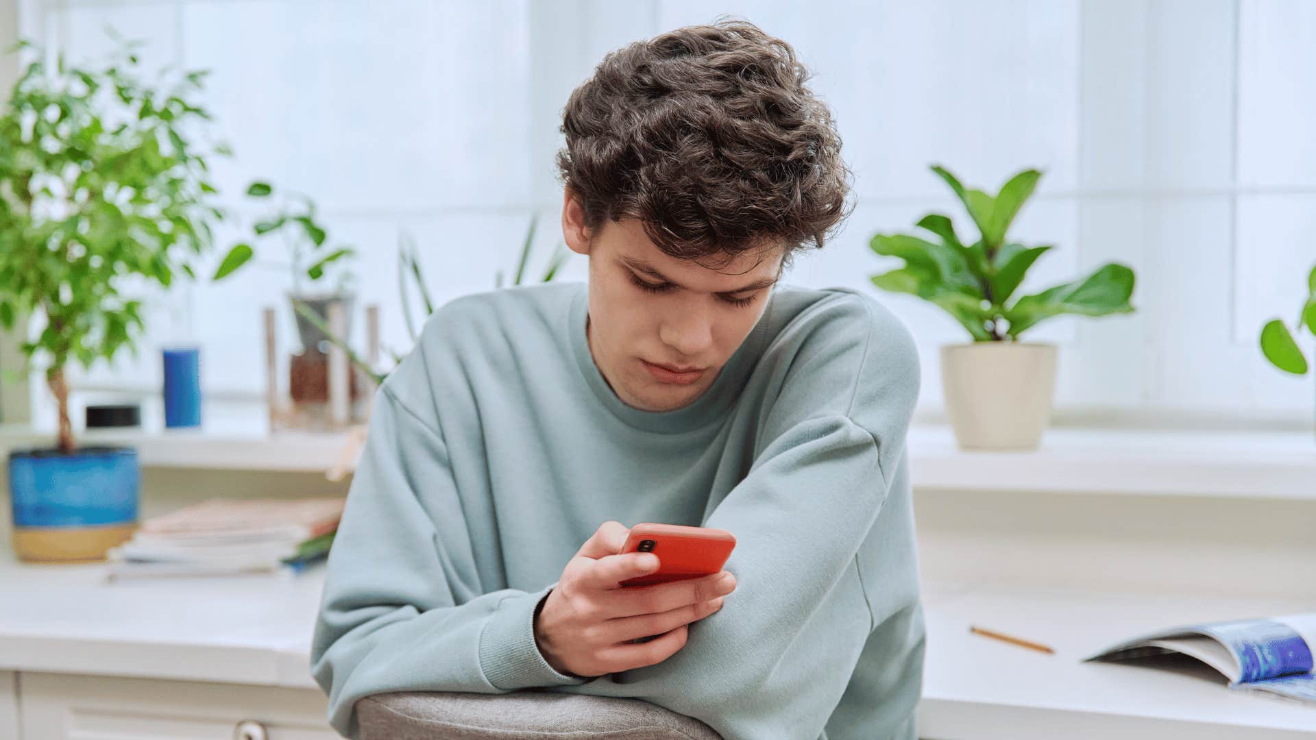 teen boy looking at phone