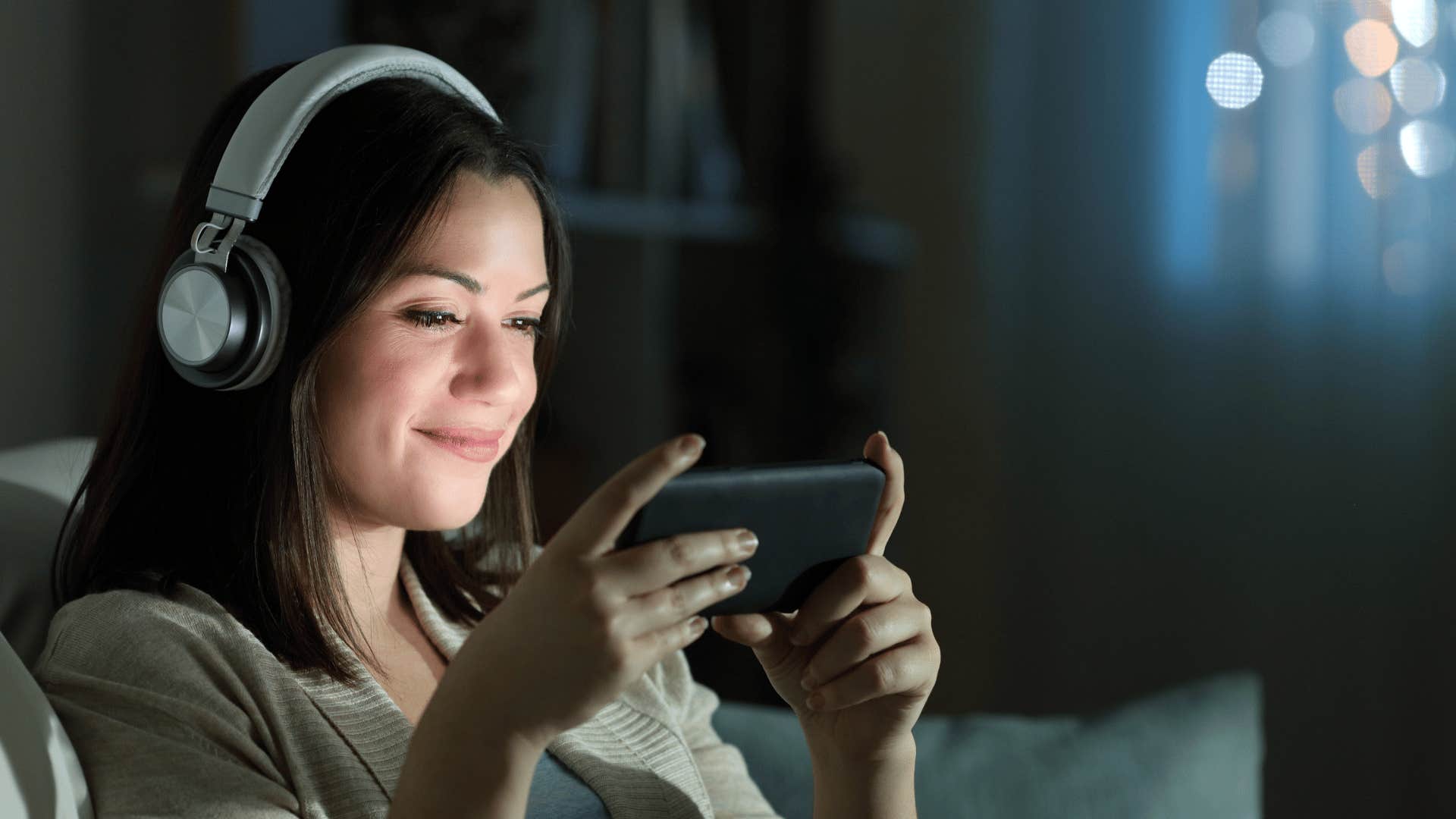 young woman watching a movie on her phone