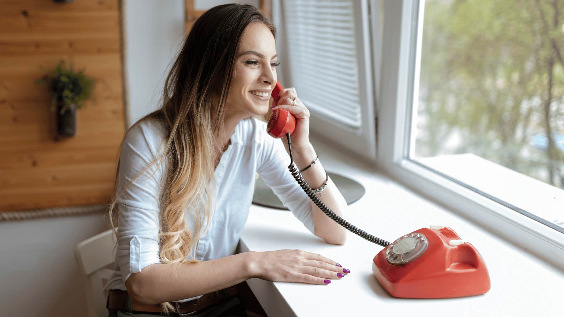 woman talking on rotary phone