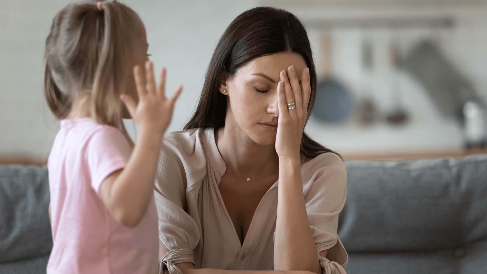 stressed mom next to child